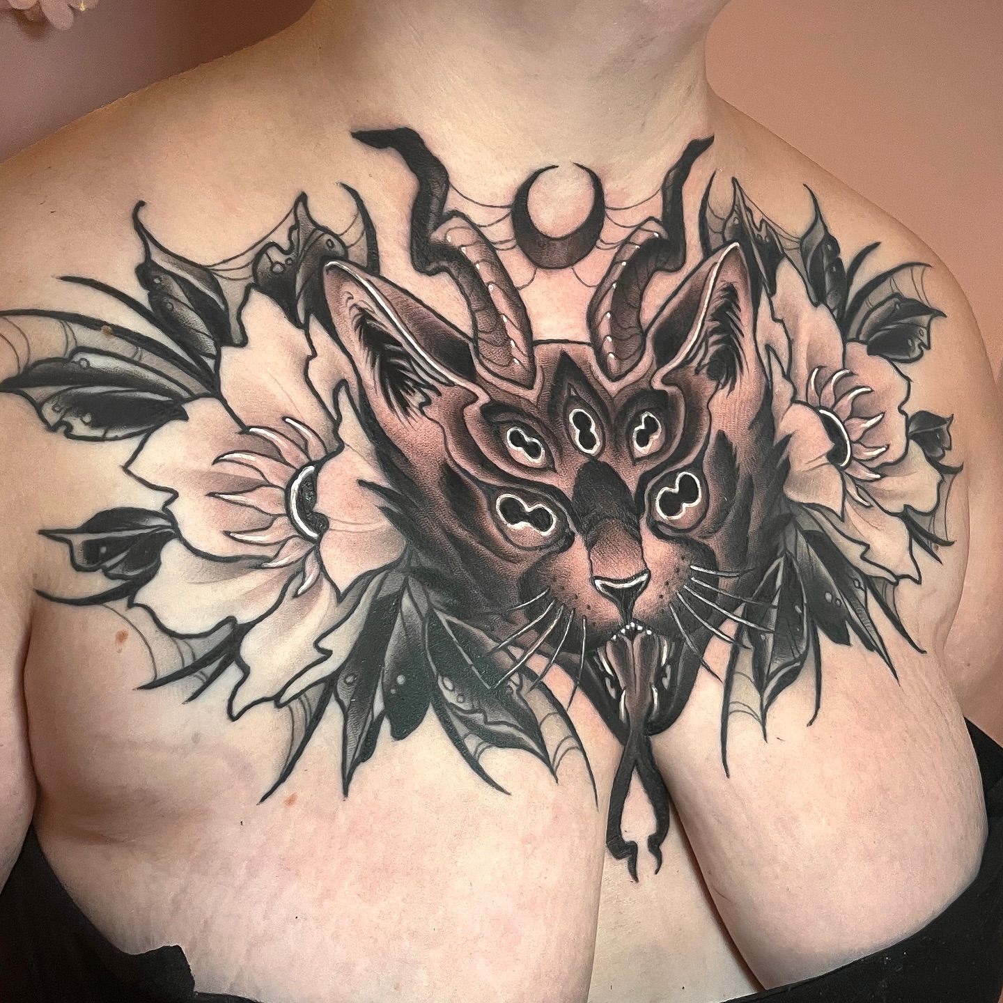 Cat and flowers black and grey tattoo on the chest by Corra Carmine