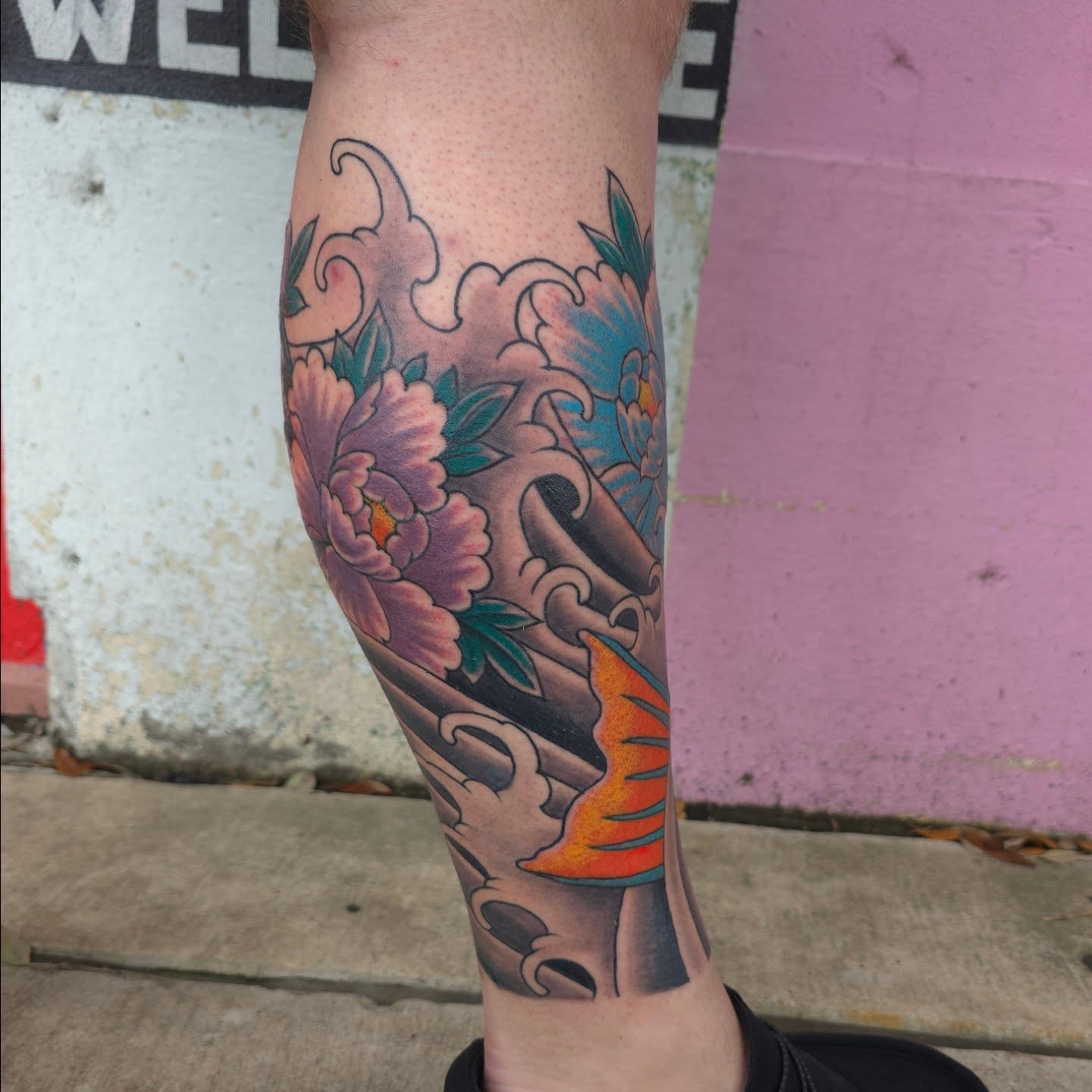 Peony and koi American traditional tattoo on the calf by Jared Green