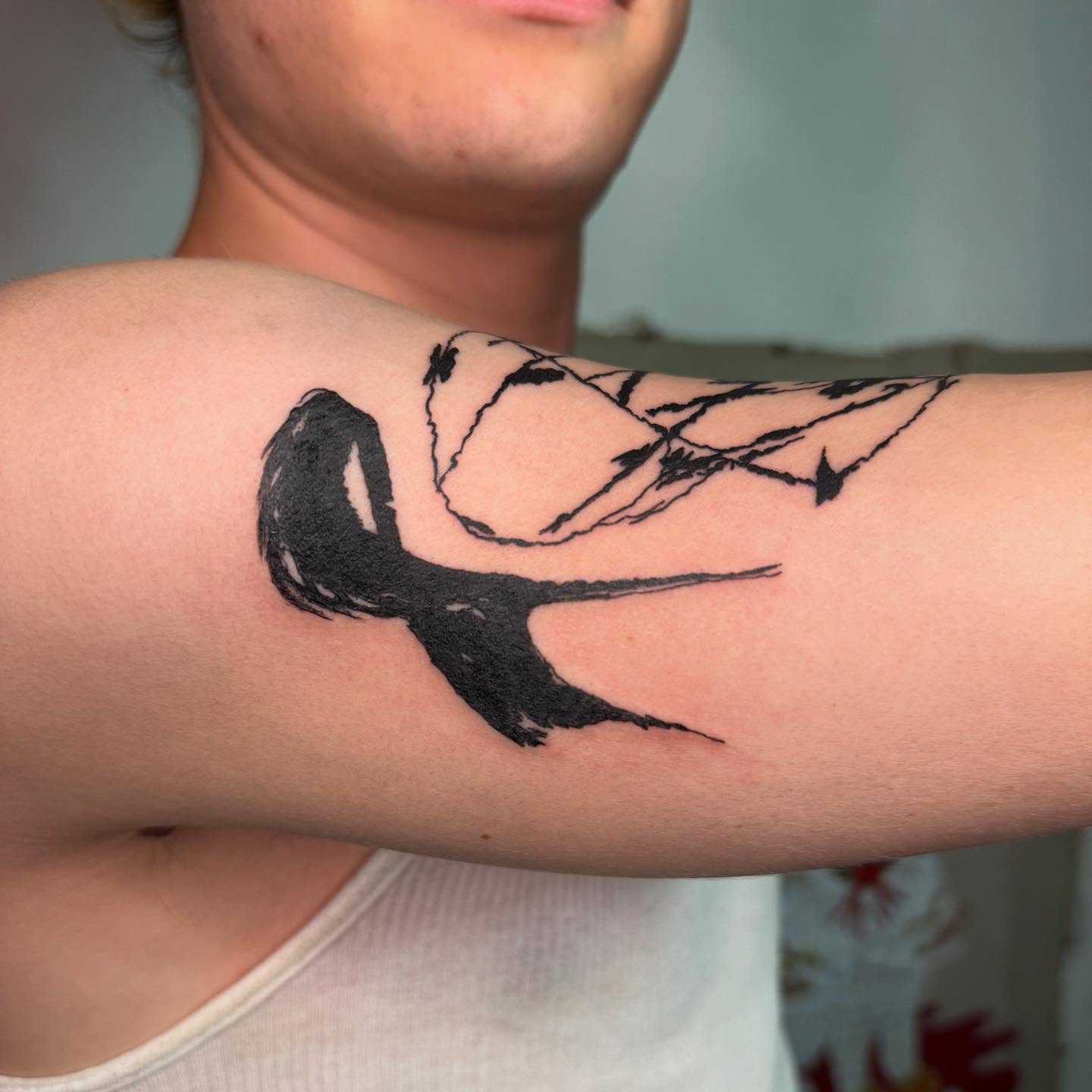 Swallow black and grey tattoo on the forearm by @godsfirmgrip