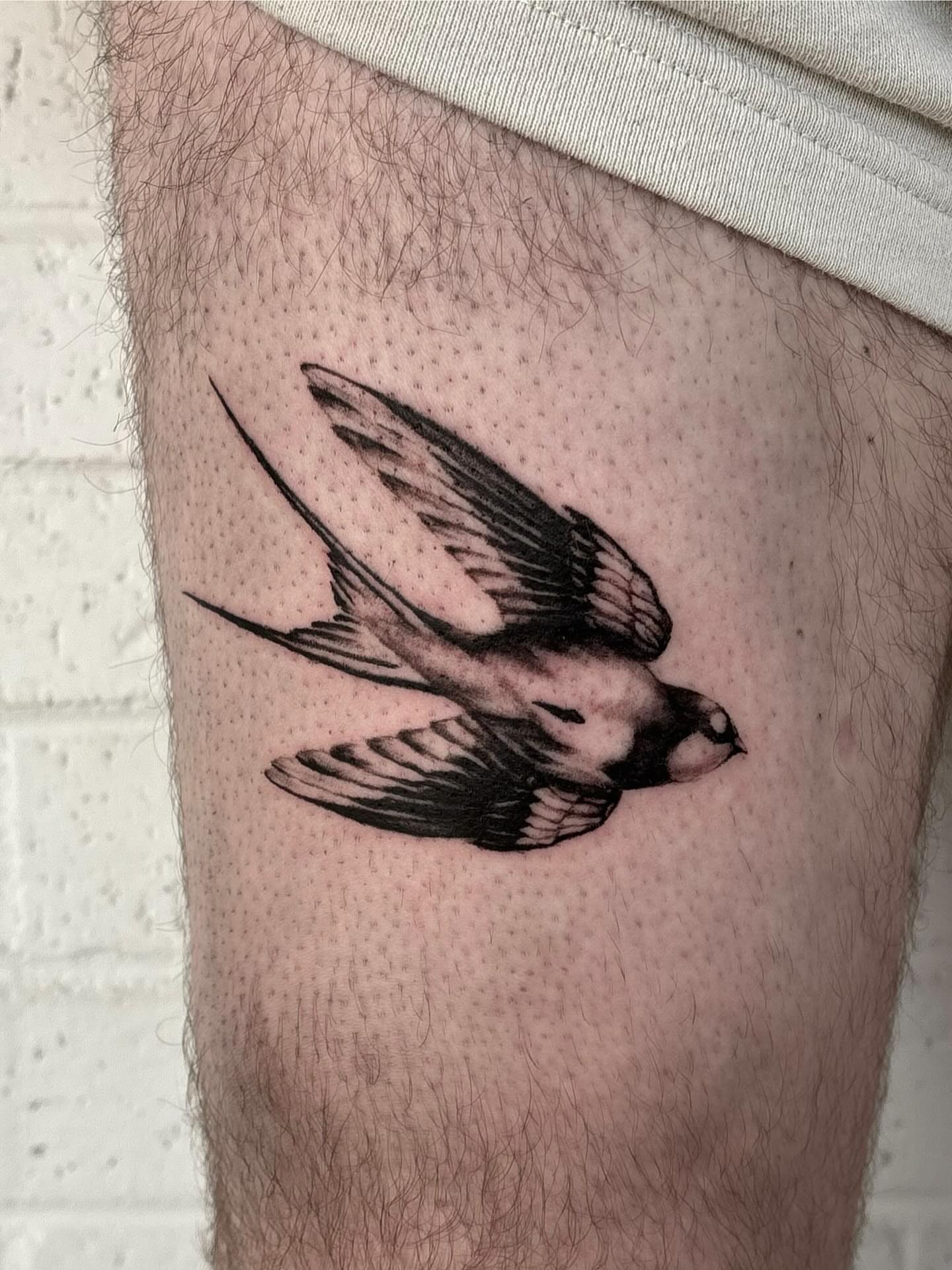 Swallow black and grey tattoo on the thigh by jordy