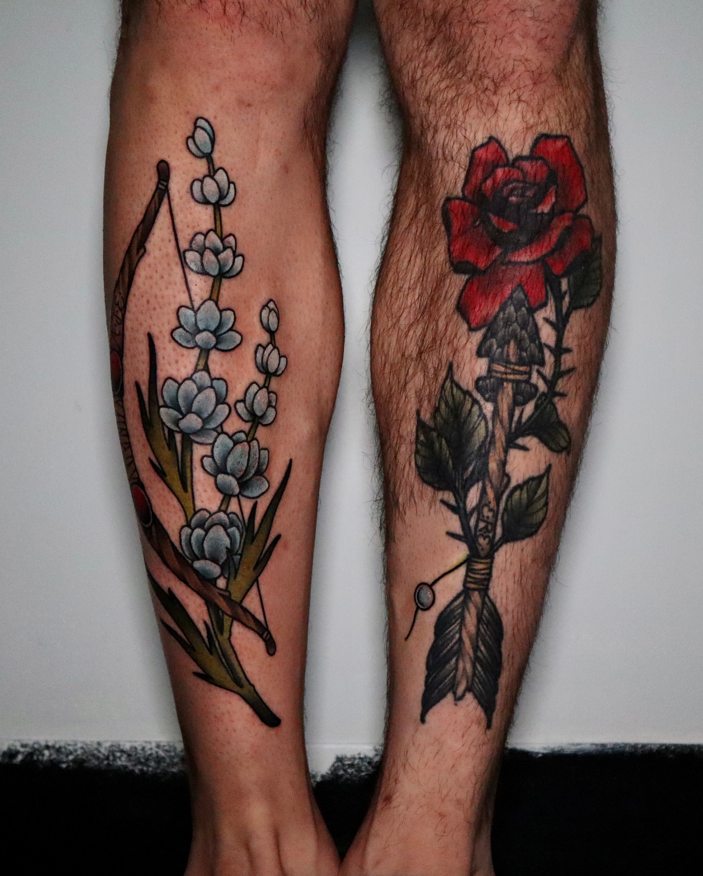 Flowers and arrow American traditional tattoo on the calf by Lauren Howard Tattoos