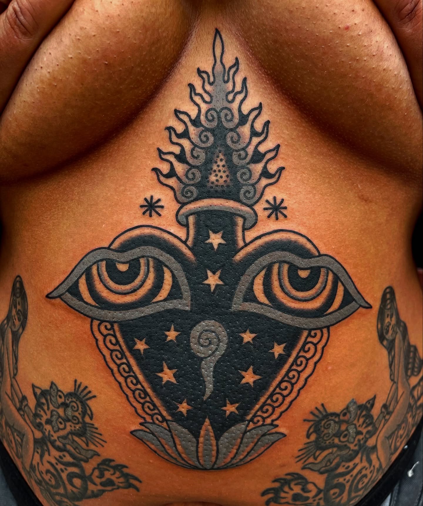 Eye and flame American traditional tattoo on the chest by Swasthik Iyengar, New York, New York
