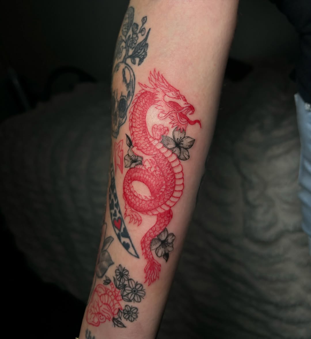 Red dragon with flowers Japanese tattoo on the forearm by Victoria