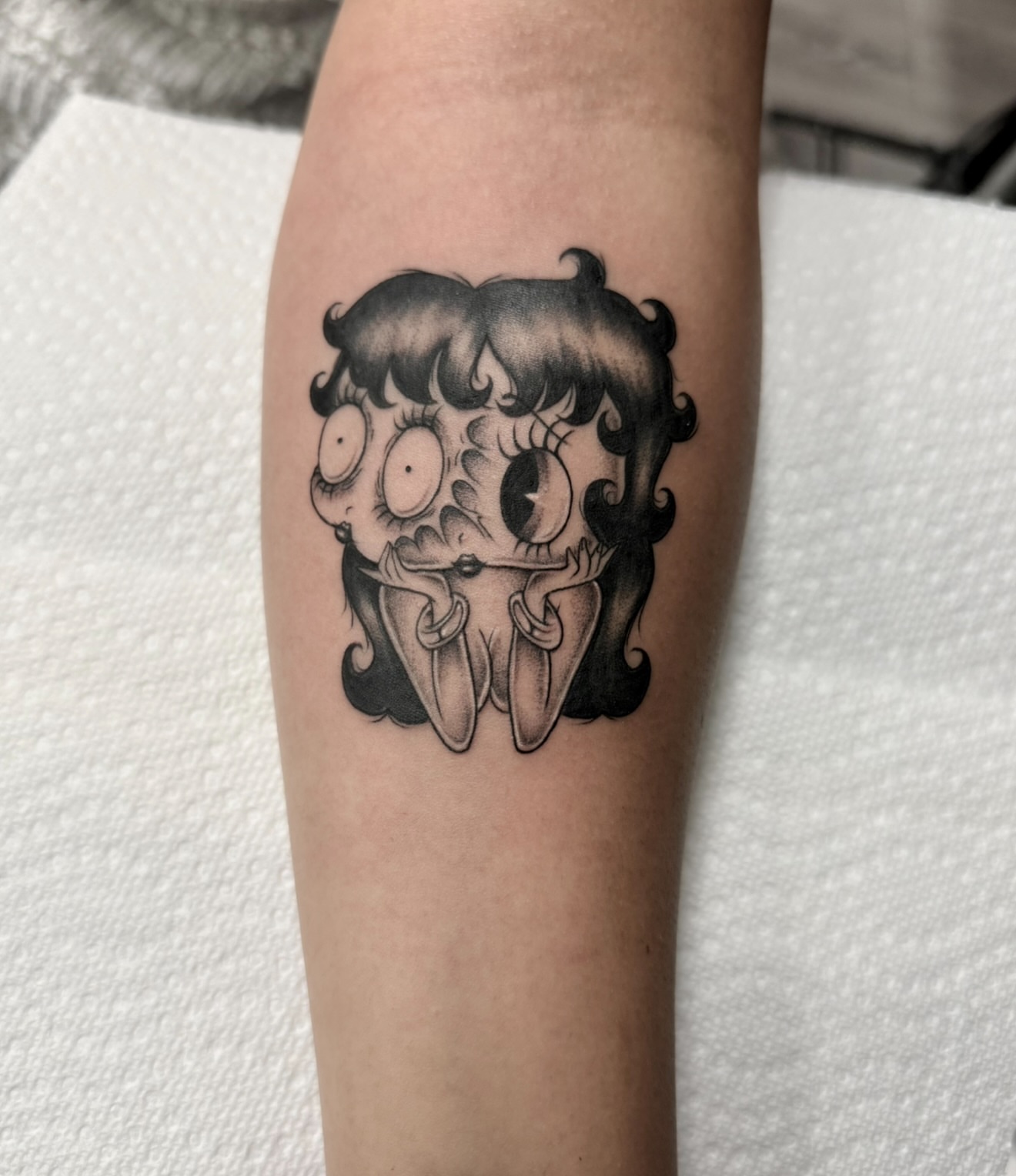 Betty Boop black and grey tattoo on the forearm by dinah