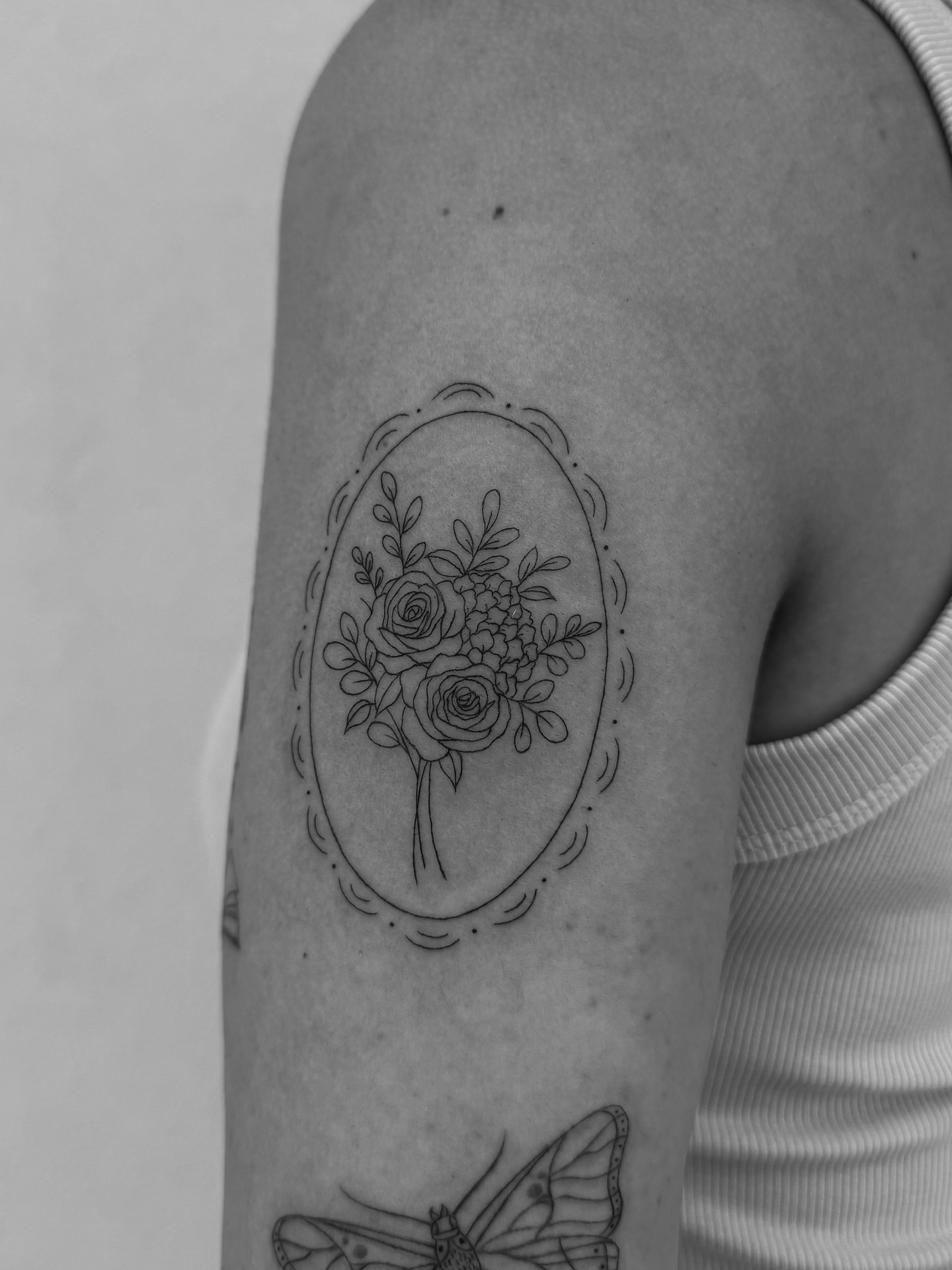 Flower bouquet fine line tattoo on the forearm by Abby Robinson