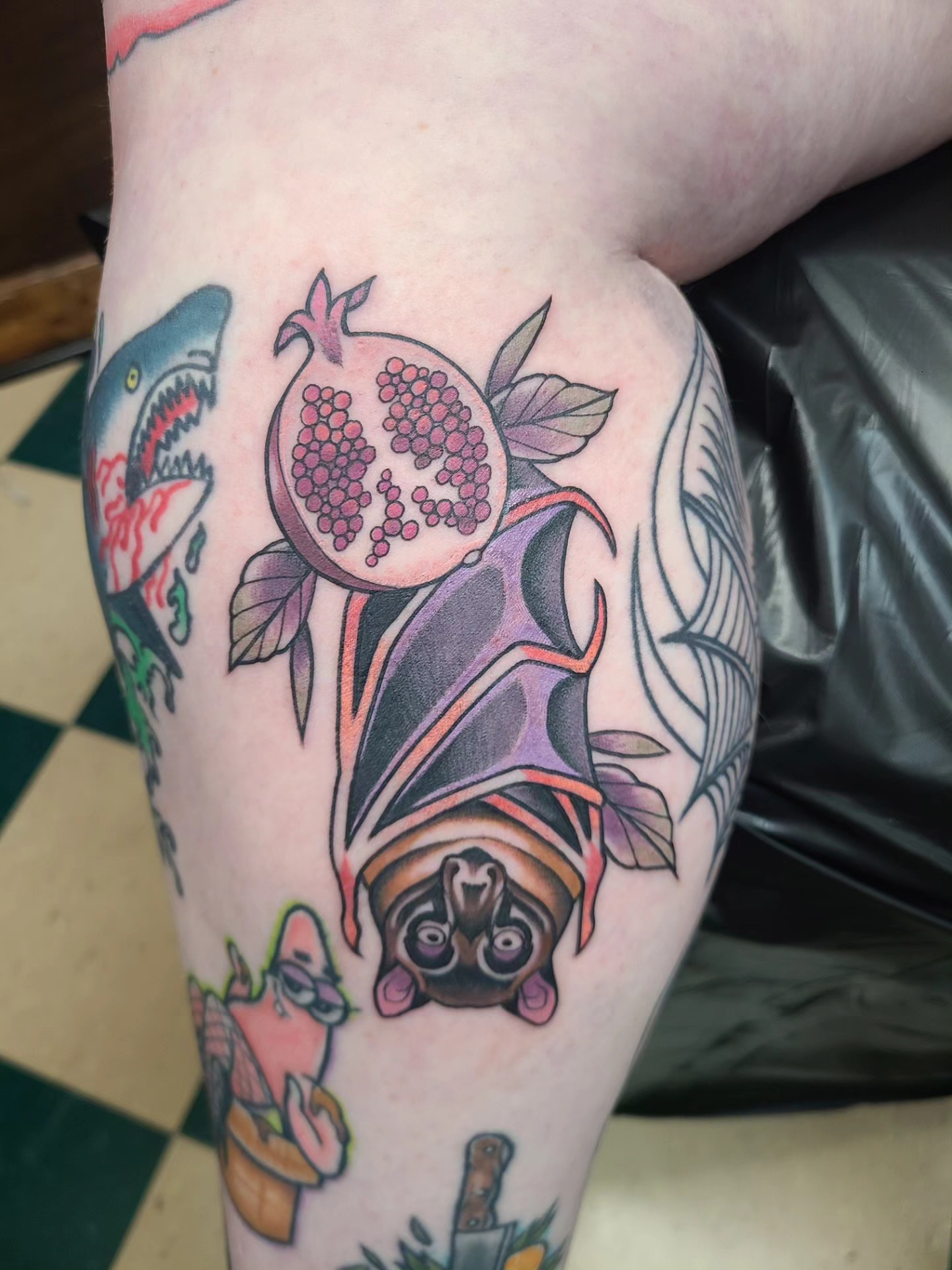 Bat and pomegranate American traditional tattoo on the forearm by David Vodicka