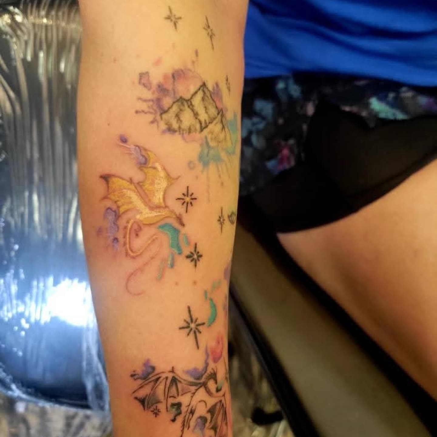 Mountain and dragon watercolor tattoo on the forearm by Naez Ink AKA Renae Madison, Macomb, Illinois