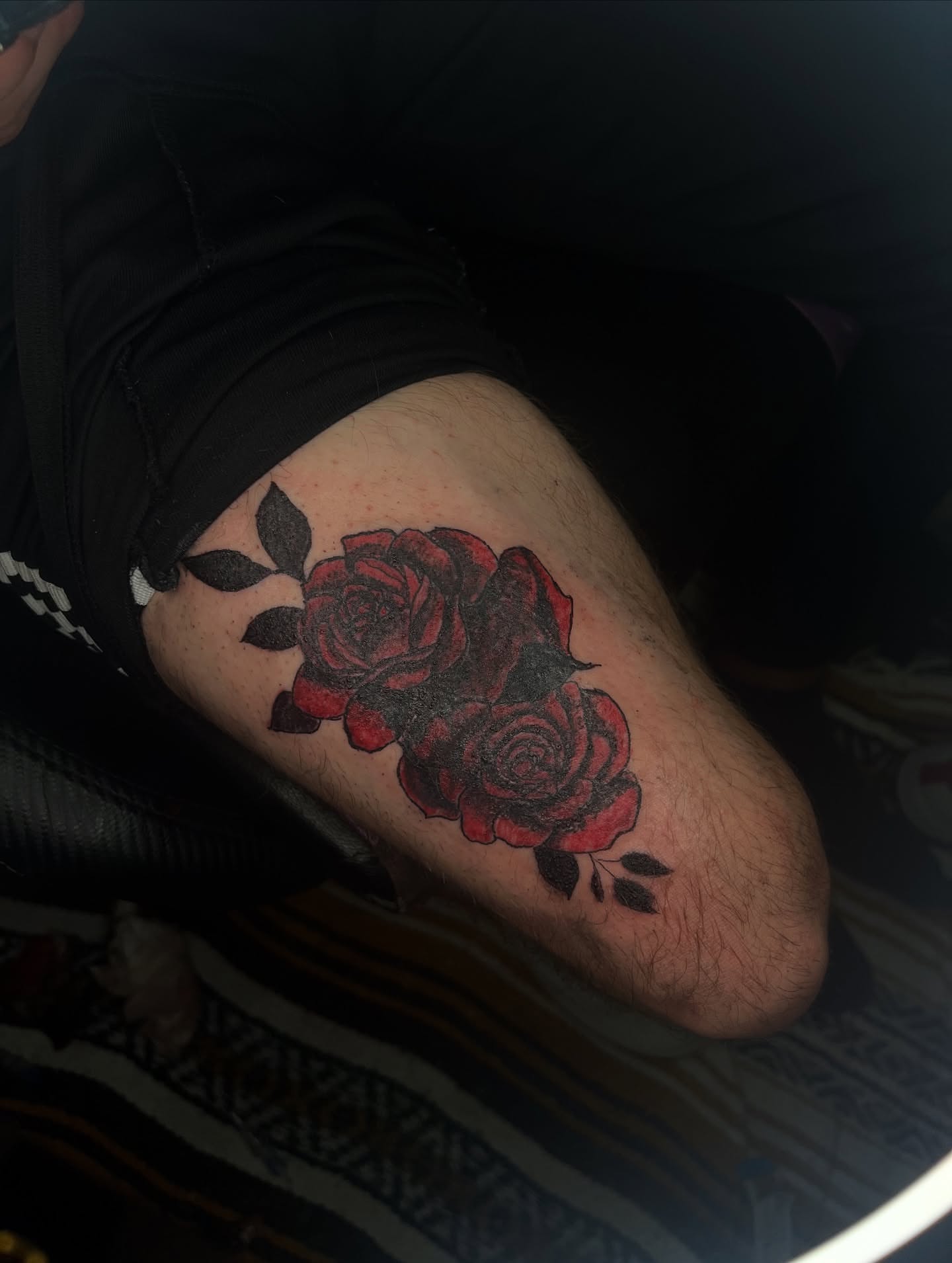 Red roses black and grey tattoo on the thigh by Winter j