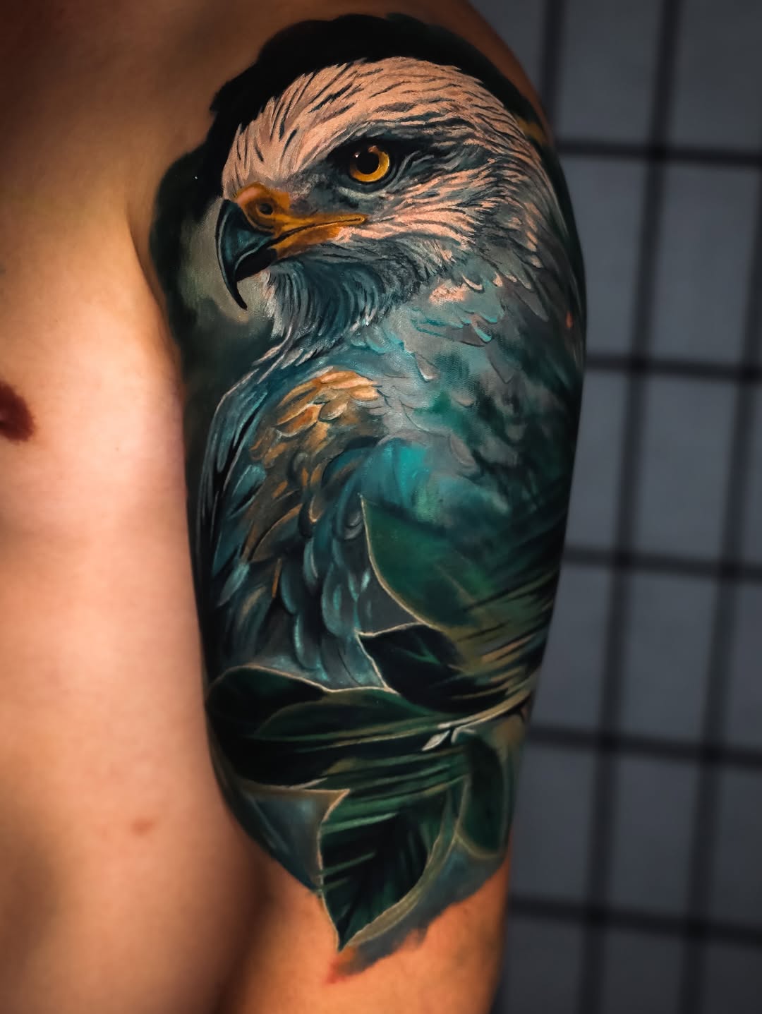 Eagle head and feathers realism tattoo on the forearm by angel.antonio.tattoos