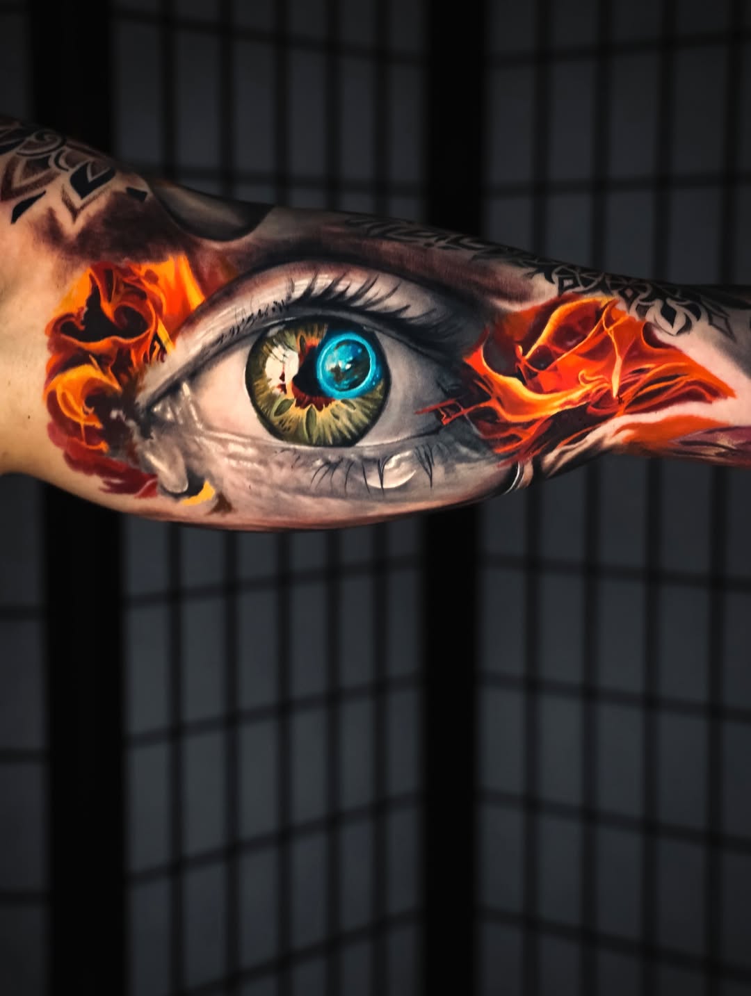 Eye with flames watercolor tattoo on the forearm by angel.antonio.tattoos