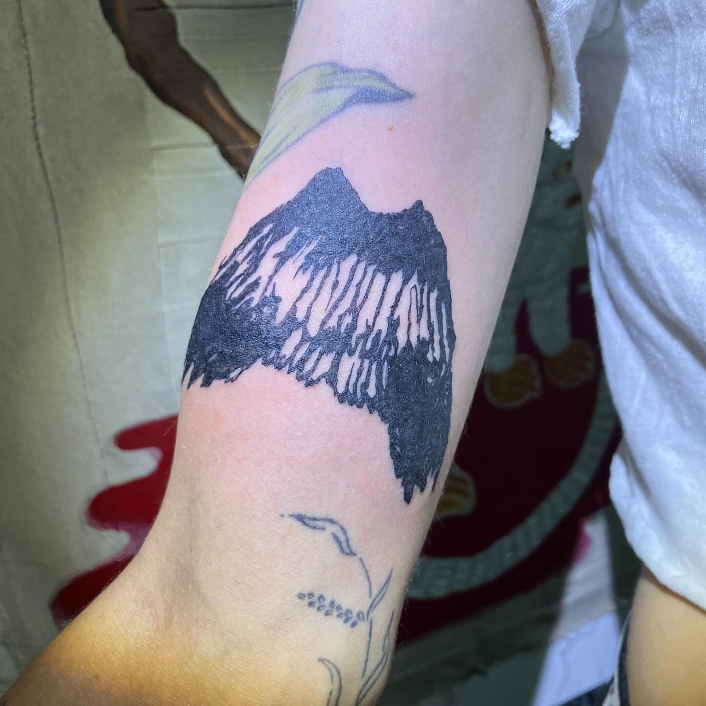 Wing black and grey tattoo on the forearm by @godsfirmgrip