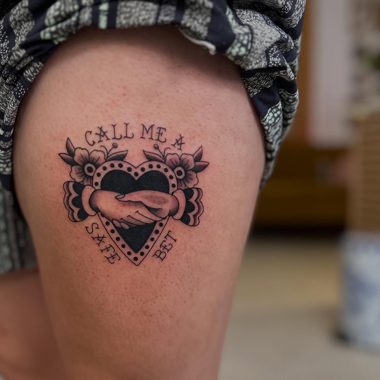 Heart with handshake American traditional tattoo on the thigh by Abigail Townsend