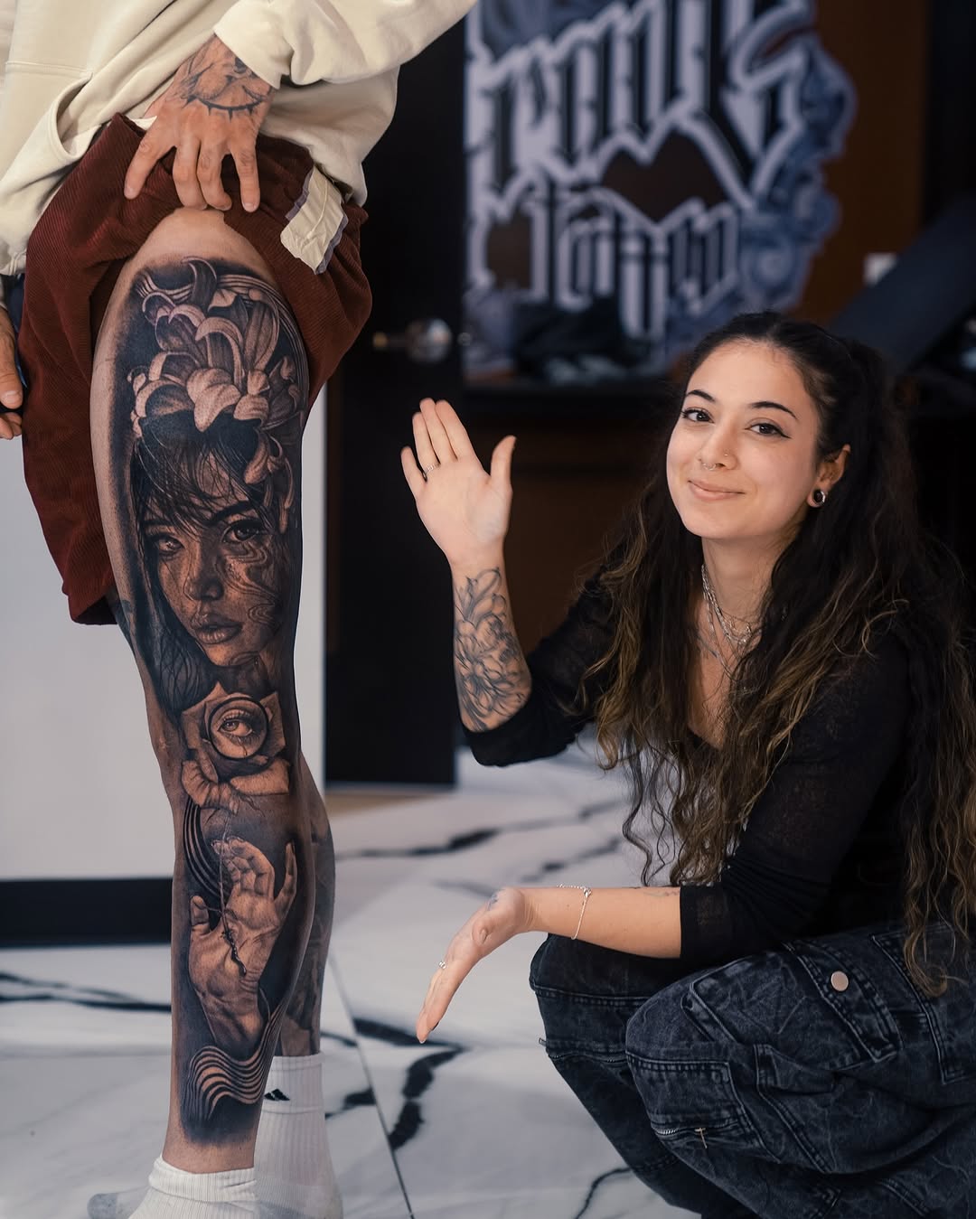 Portrait with flowers and hand surrealism tattoo on the leg by Mia