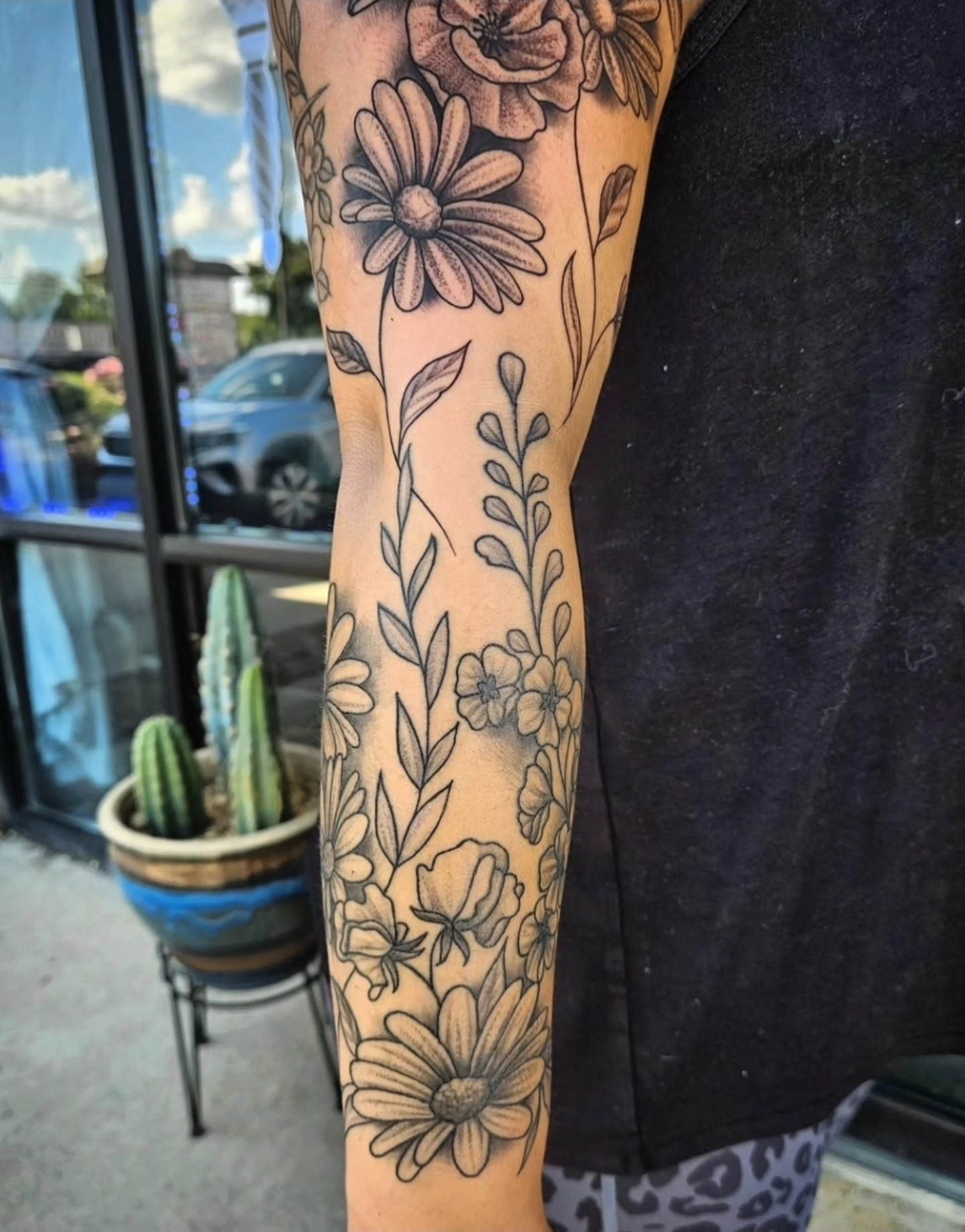 Floral bouquet black and grey tattoo on the forearm by Mike Bugenhagen