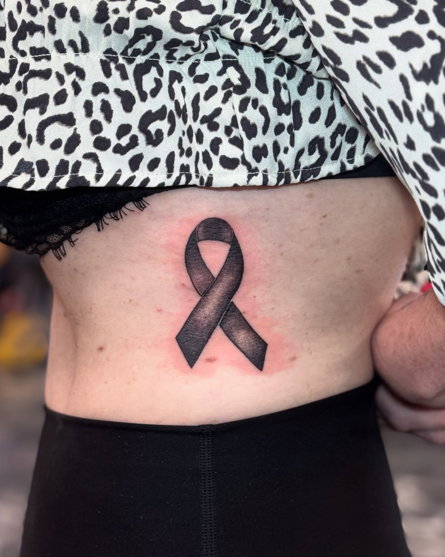 Black ribbon black and grey tattoo on the torso by Paola Pineda Tattoo, Knoxville, Tennessee
