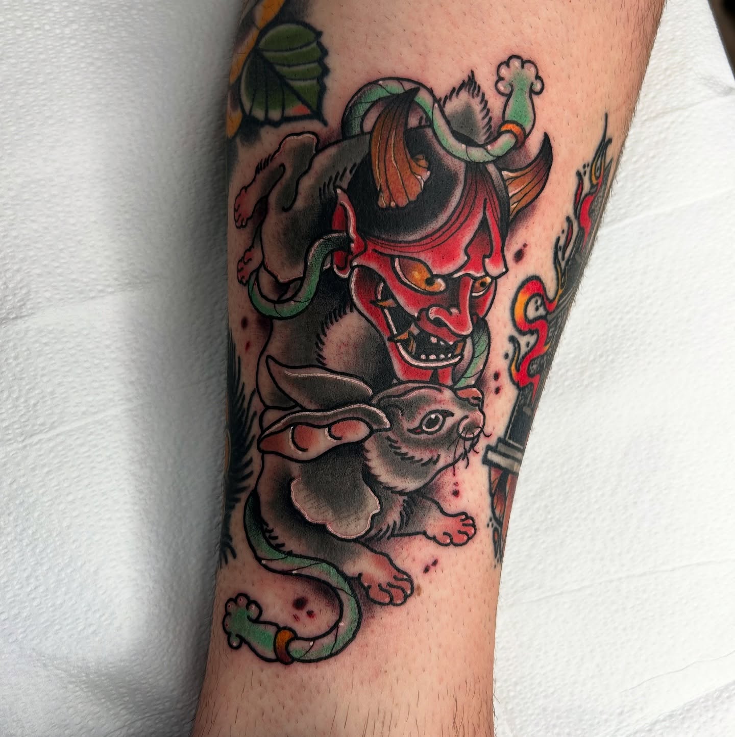 Demon and rabbit American traditional tattoo on the forearm by Noah Crow