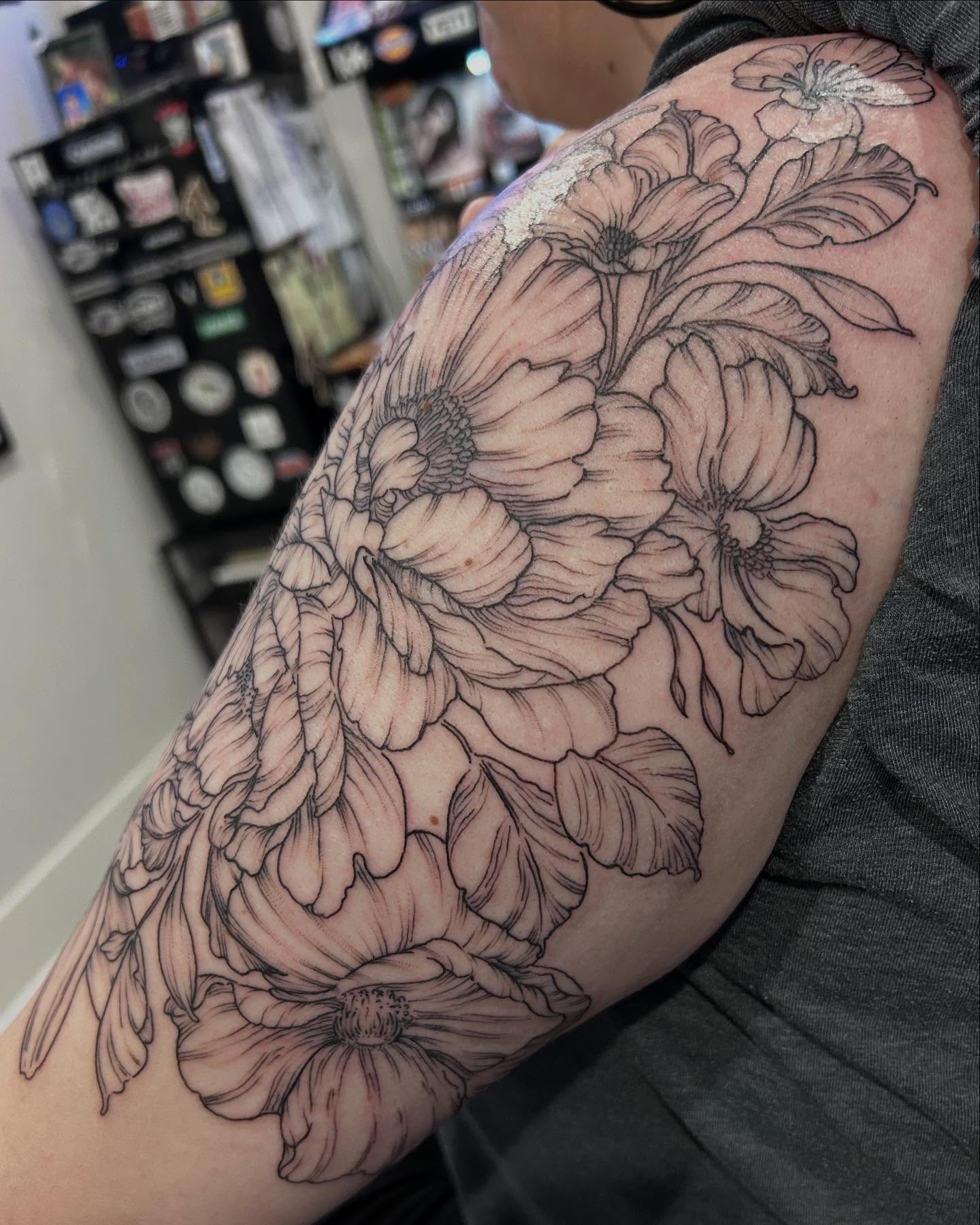 Flowers black and grey tattoo on the upper arm by Jbtattoo Artistry