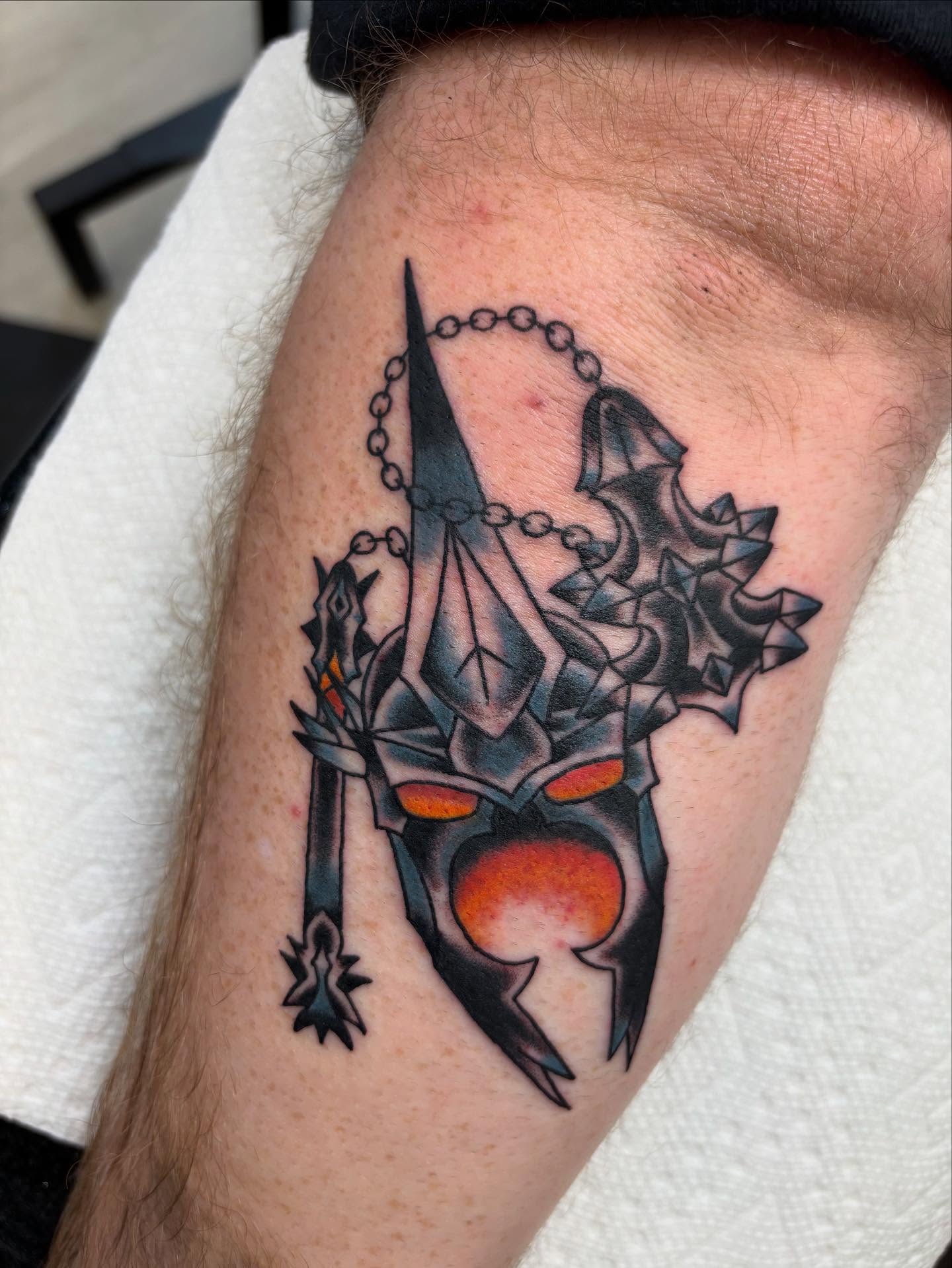 Geometric mask geometric tattoo on the forearm by Ben Whyte