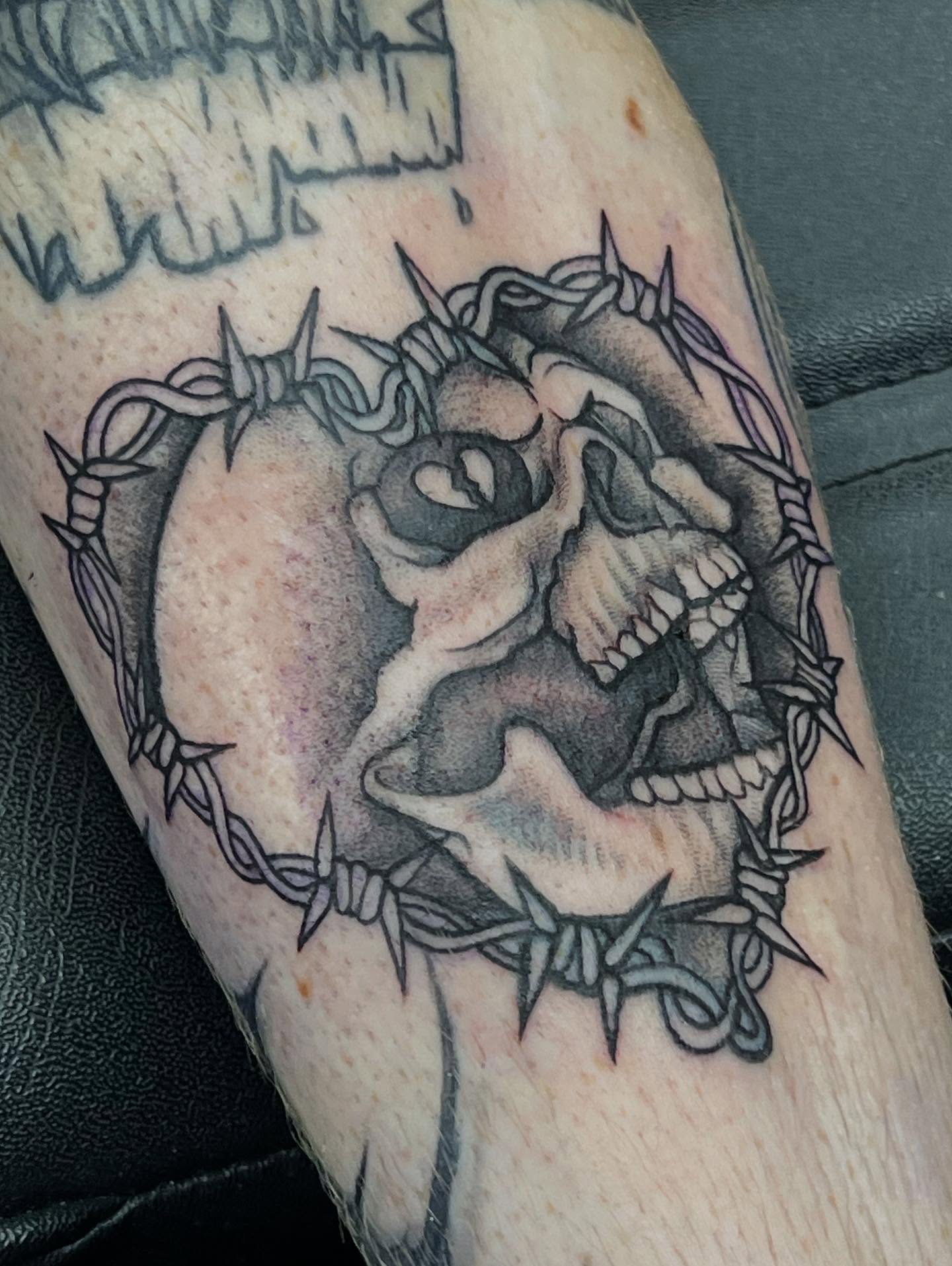 Barbed wire skull black and grey tattoo on the forearm by Sav