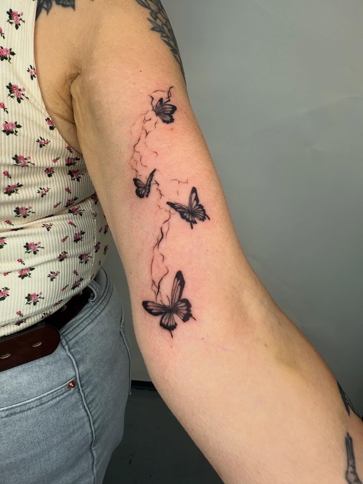 Butterflies black and grey tattoo on the forearm by Joey tattoo