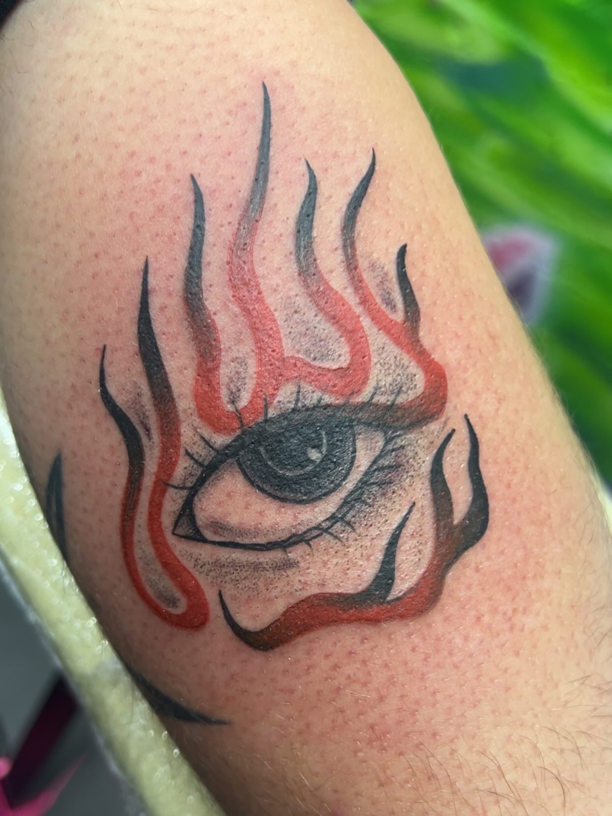 Eye with flames realism tattoo on the shoulder by Sav