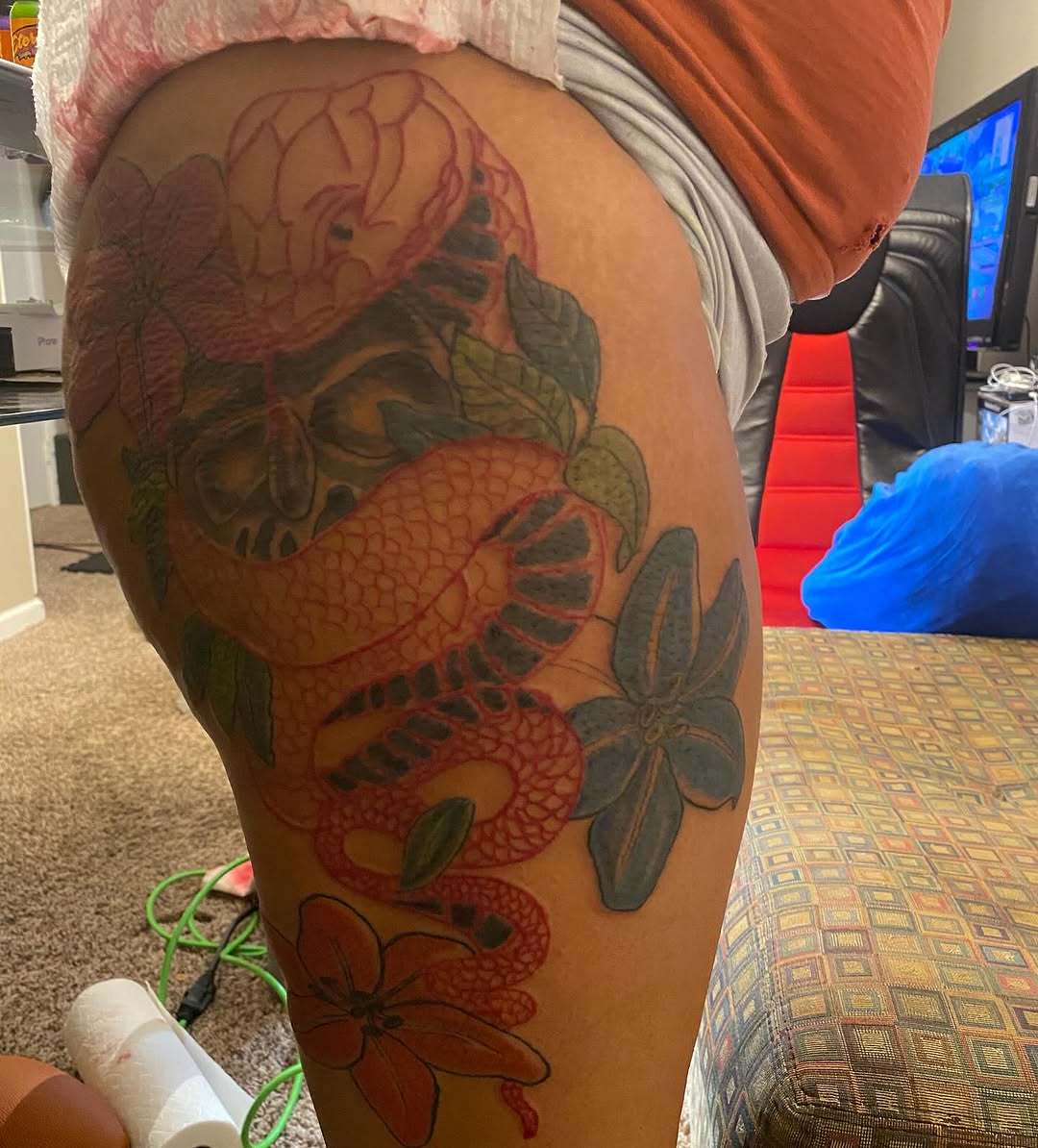 Snake and skull with flowers Japanese tattoo on the thigh by Family and Loyalty
