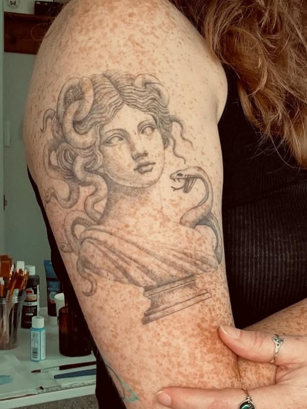 Medusa bust black and grey tattoo on the upper arm by Rachel