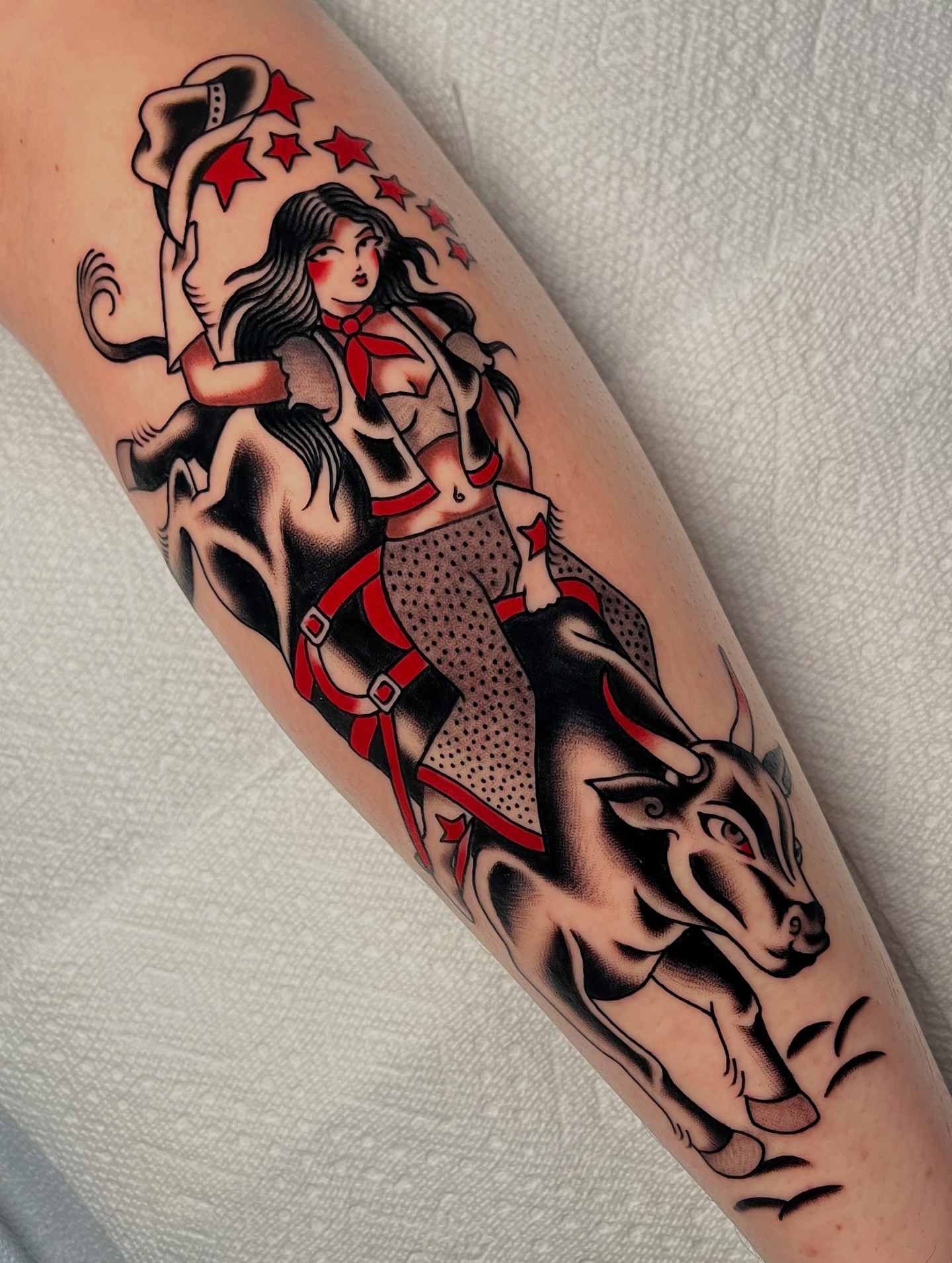 Woman riding bull American traditional tattoo on the forearm by kate