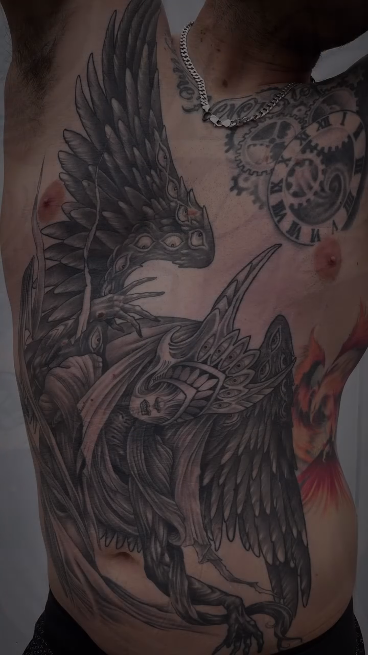 Winged creature with helmet dark realism tattoo by Tattooer by Trade Wannabe Artist at Heart