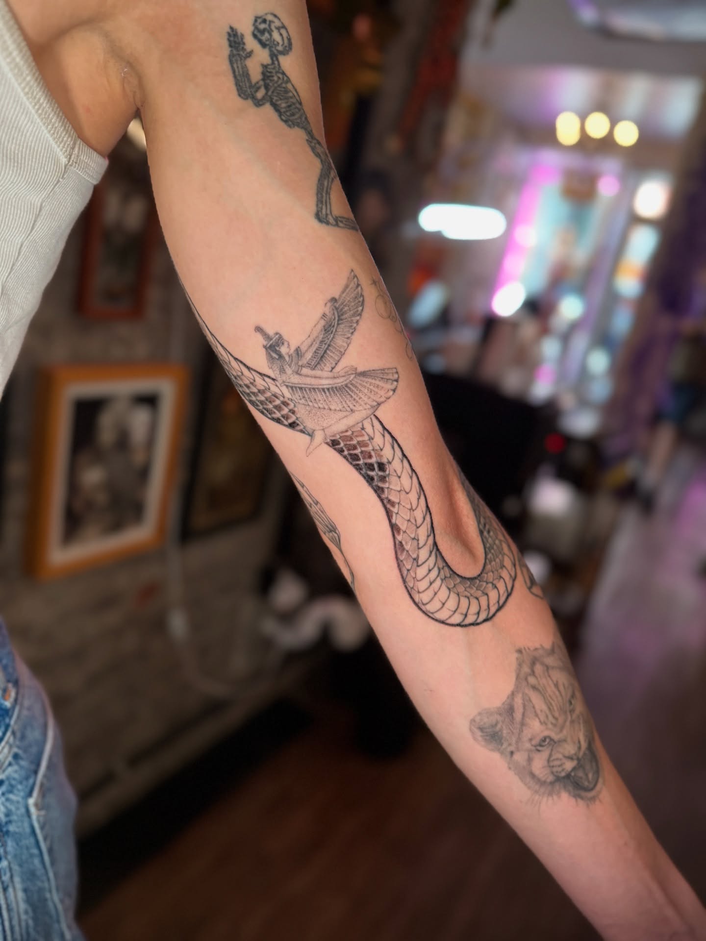 Serpent with wings black and grey tattoo on the forearm by Jon Mesa