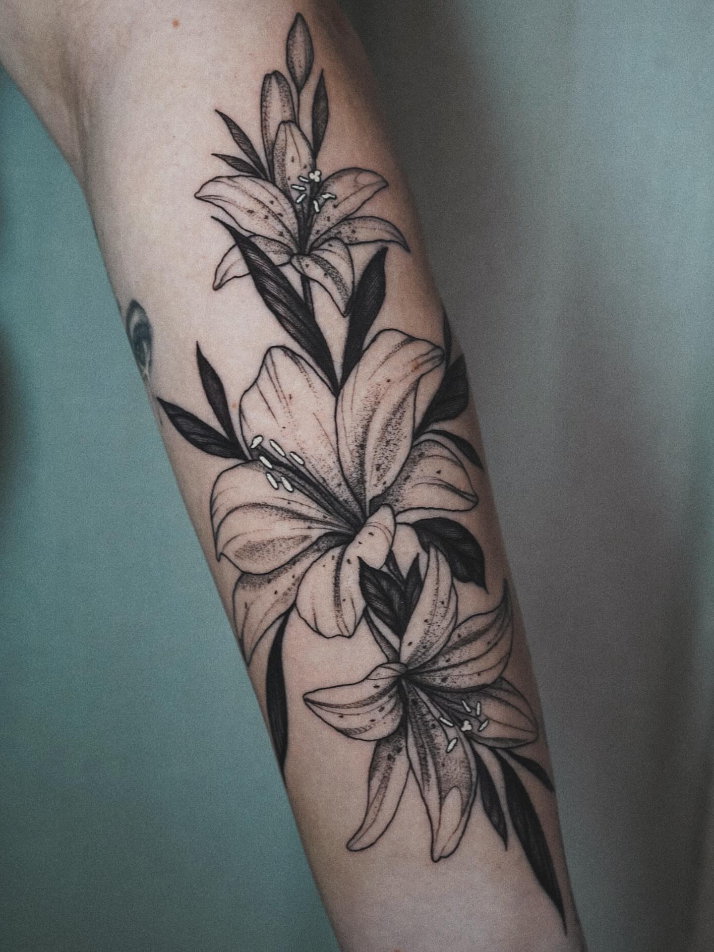 Lilies dotwork tattoo on the forearm by Katherin Plaza