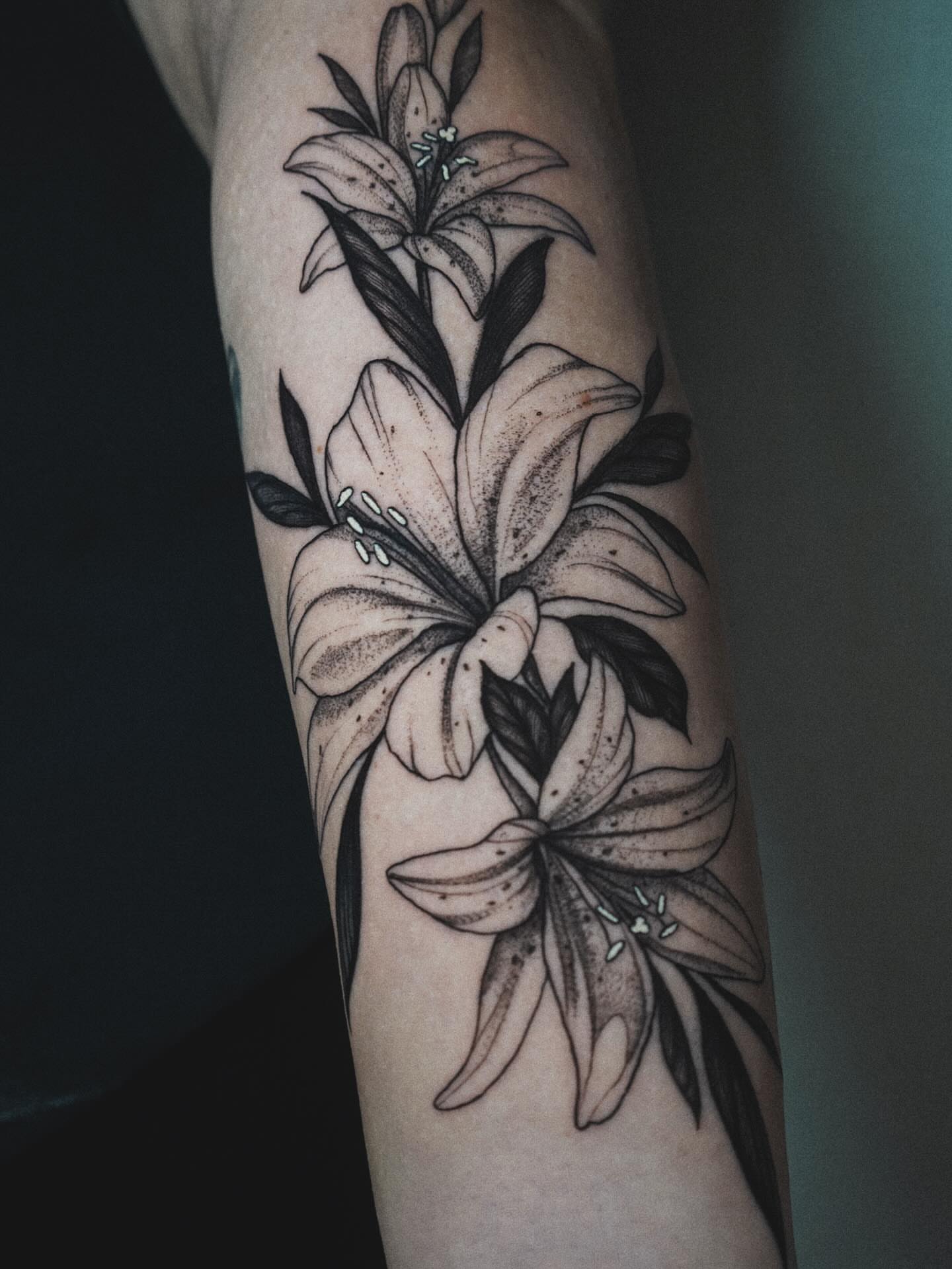 Lilies dotwork tattoo on the forearm by Katherin Plaza