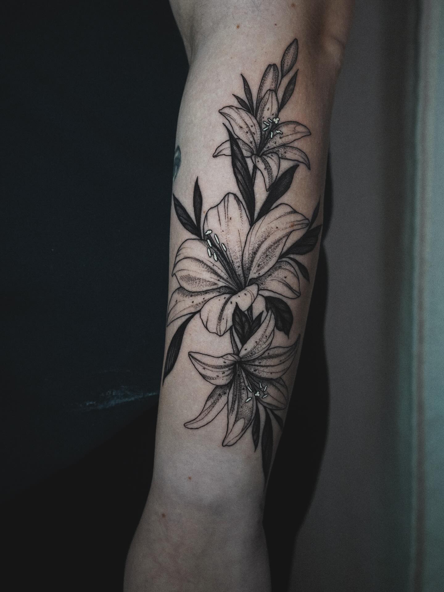 Lilies dotwork tattoo on the forearm by Katherin Plaza