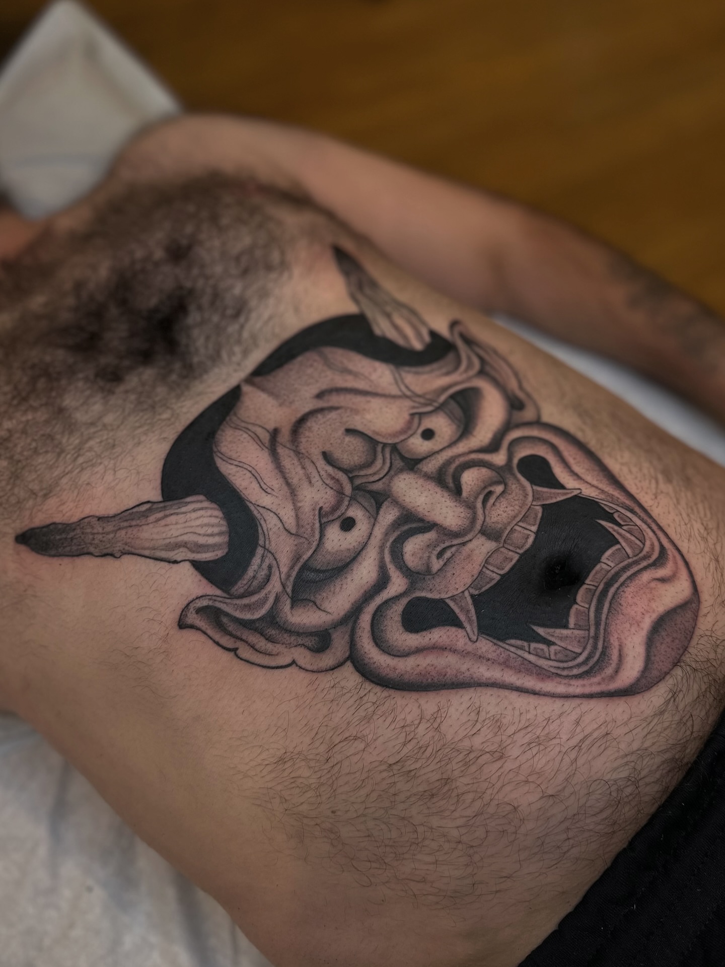 Demon mask black and grey tattoo on the chest by Адріянна Стабс 🇺🇦, New York, New York