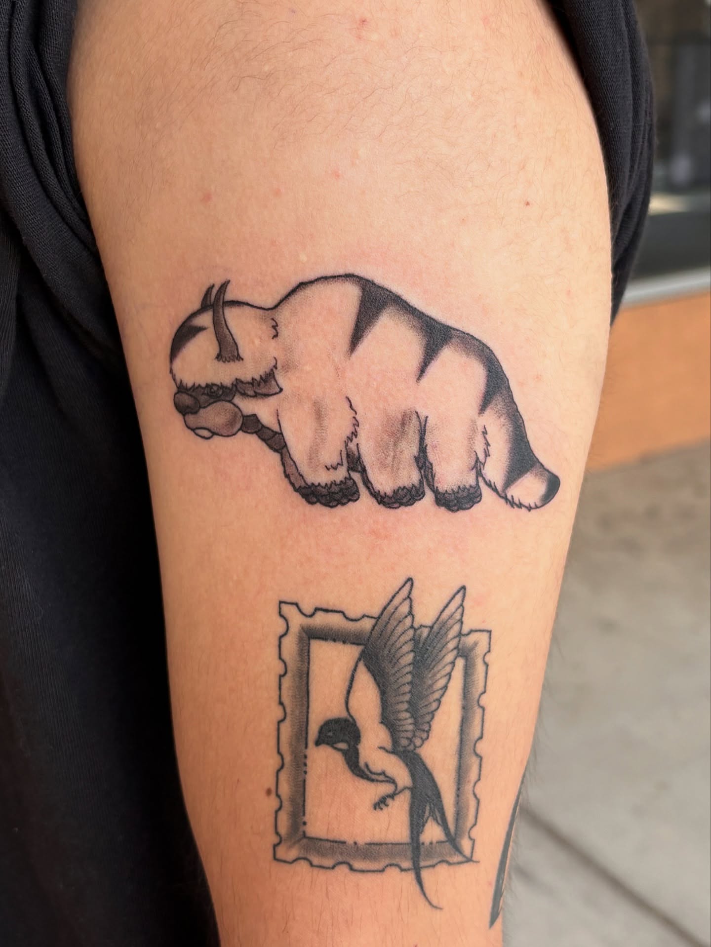 Bear and bird black and grey tattoo on the forearm by Tori Anderson, Minneapolis, Minnesota