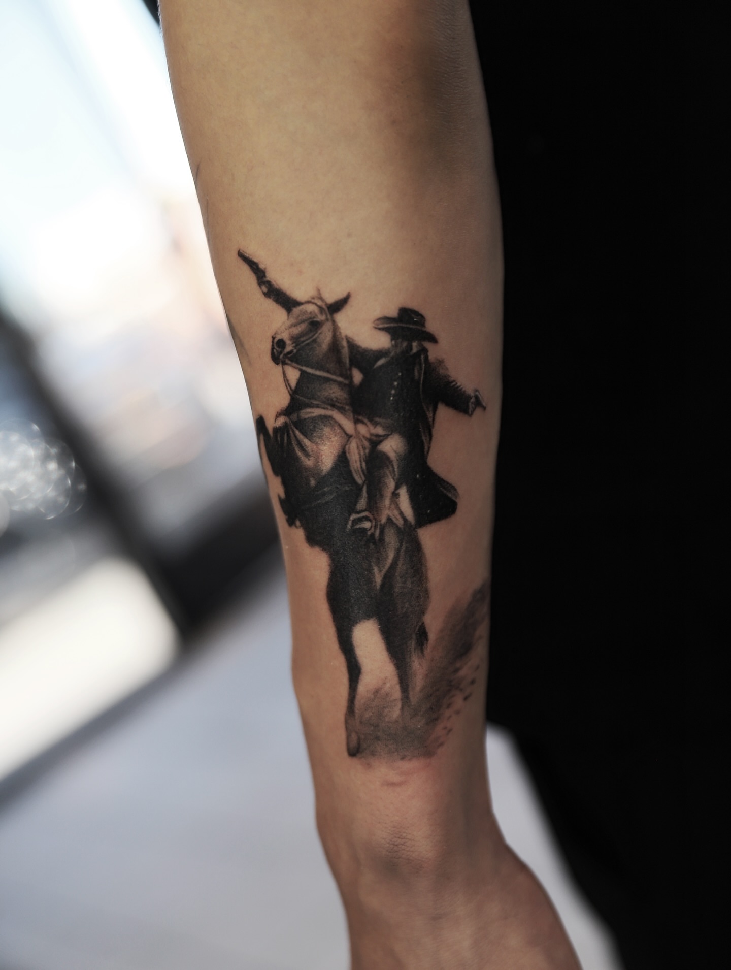 Cowboy riding bull realism tattoo on the forearm by Las Vegas tattoo