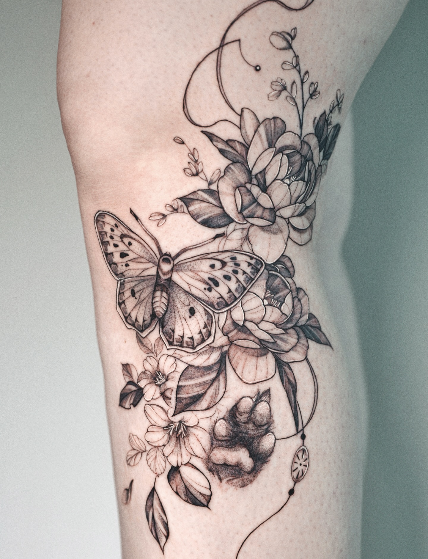 Butterfly and floral bouquet realism tattoo on the forearm by @katuvetattoo