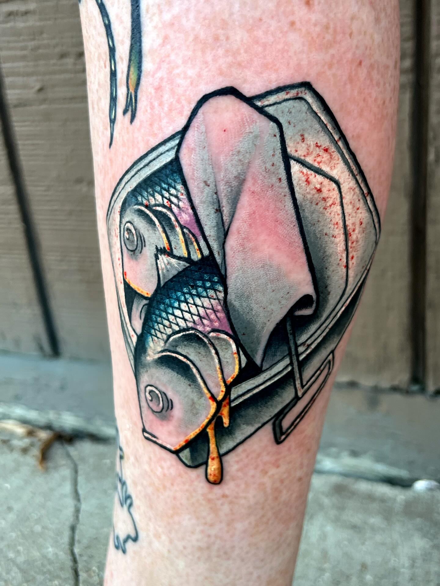 Fish in suitcase American traditional tattoo on the forearm by Kevin Starai