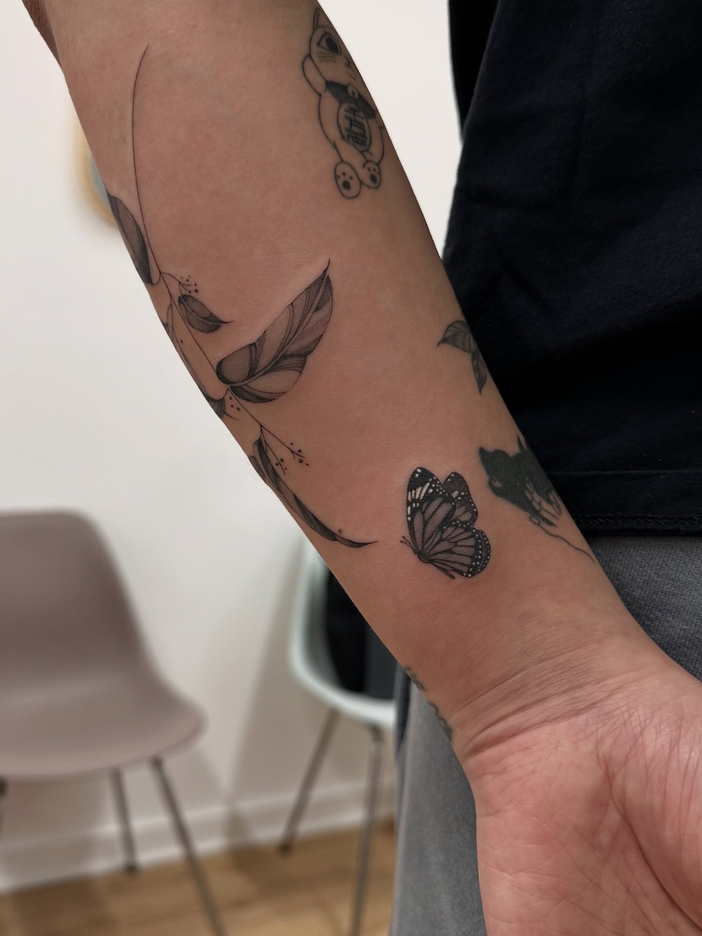 Butterfly and feathers black and grey tattoo on the forearm by Soohee Jin✨ NYC tattoo artist