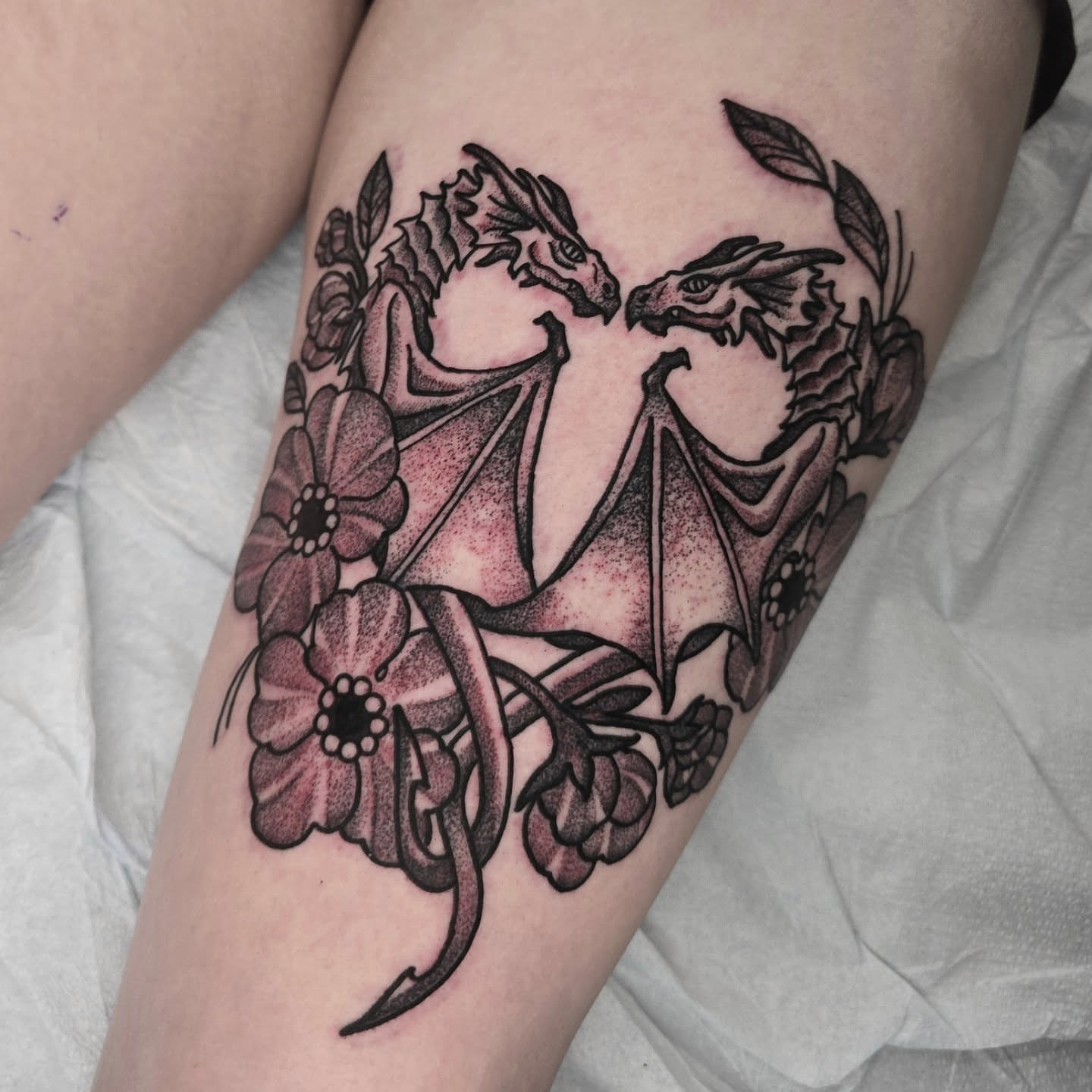Dragons and flowers dotwork tattoo on the forearm by Adison Essig