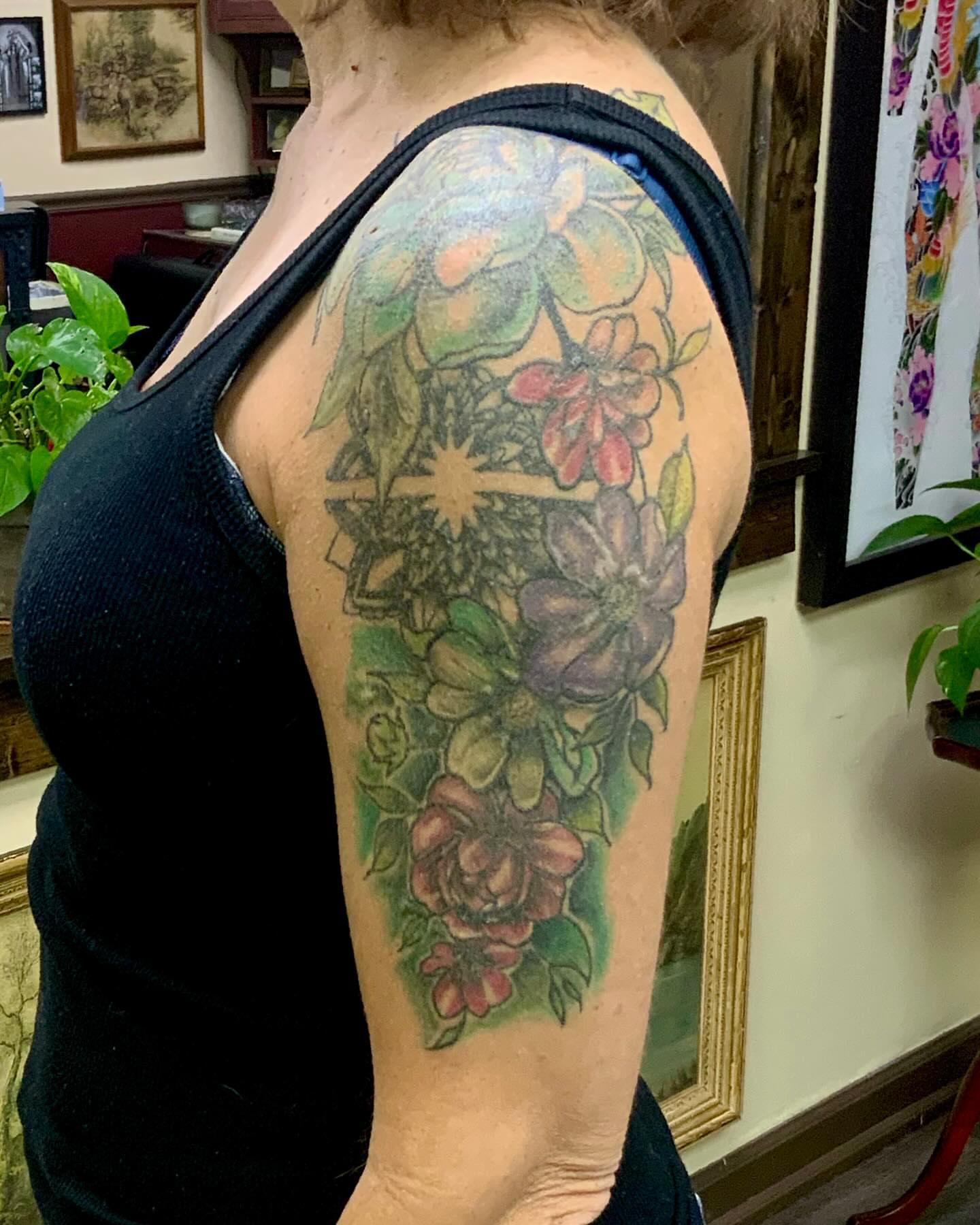 Floral bouquet realism tattoo on the upper arm by Sweets, Nashville, Tennessee