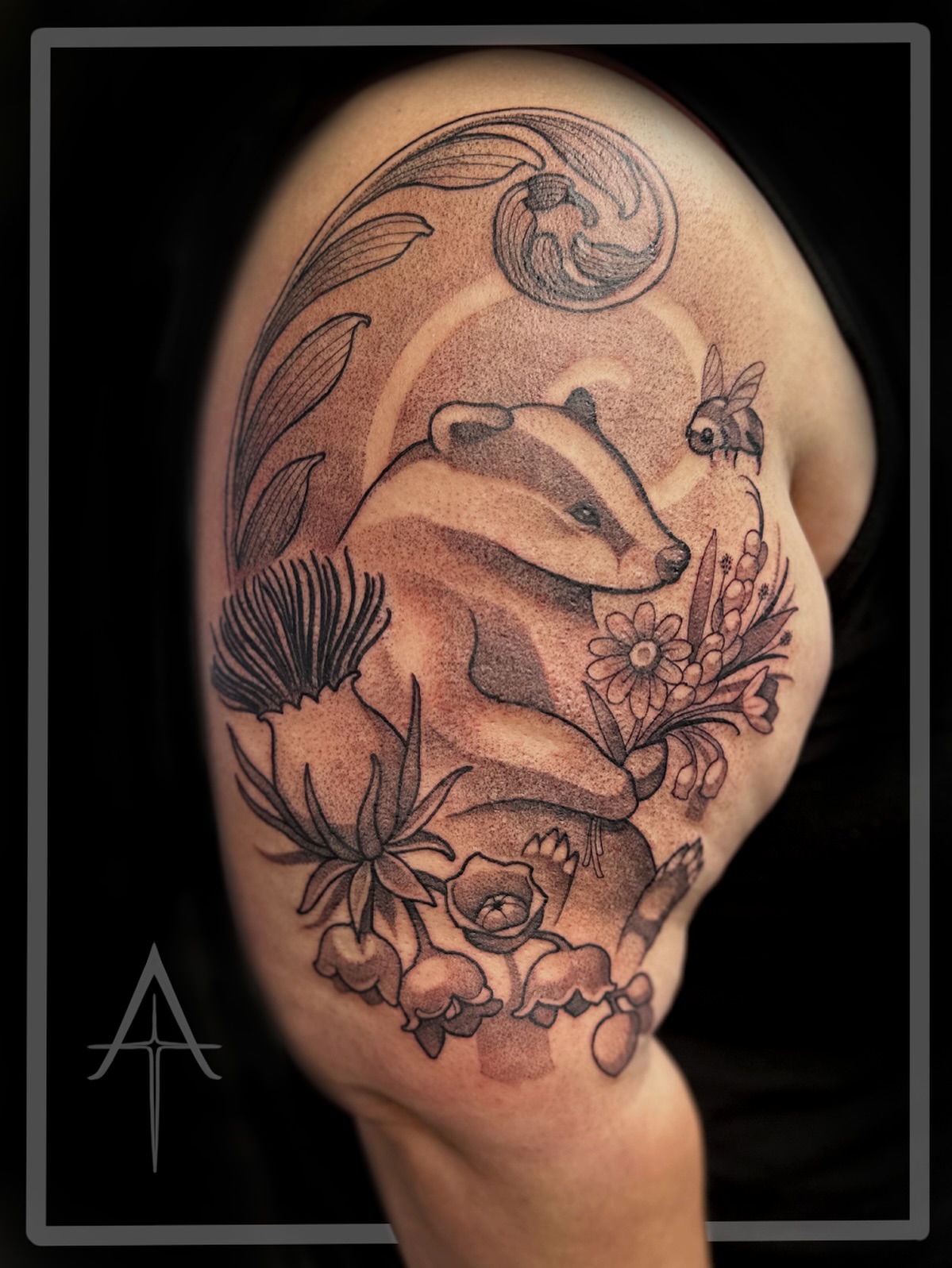 Badger and flowers dotwork tattoo on the shoulder by Chris Dobransky