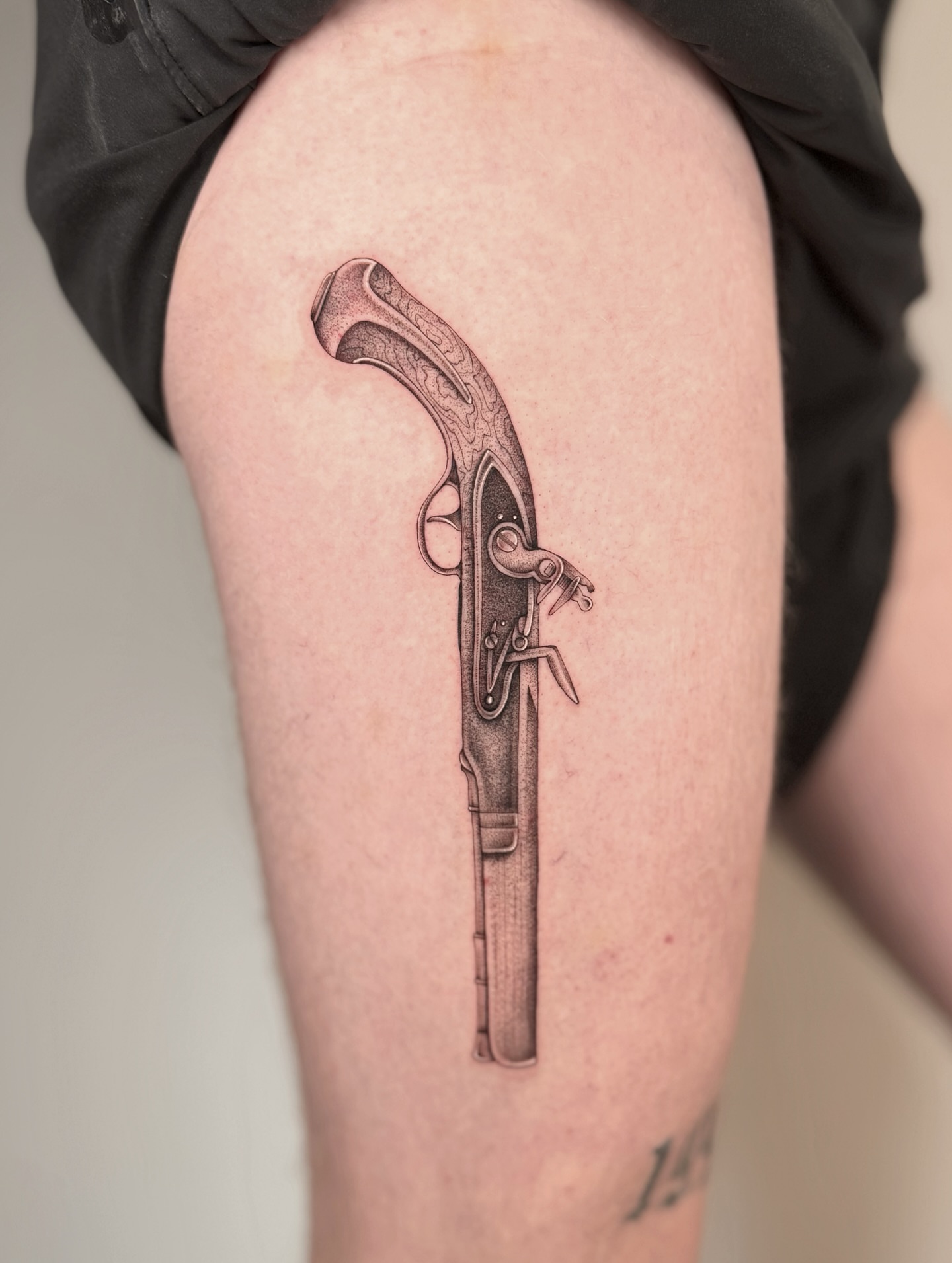 Gun black and grey tattoo on the thigh by MillaKas ° Tattoos