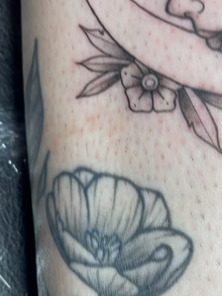 Flower black and grey tattoo on the forearm by Natalie
