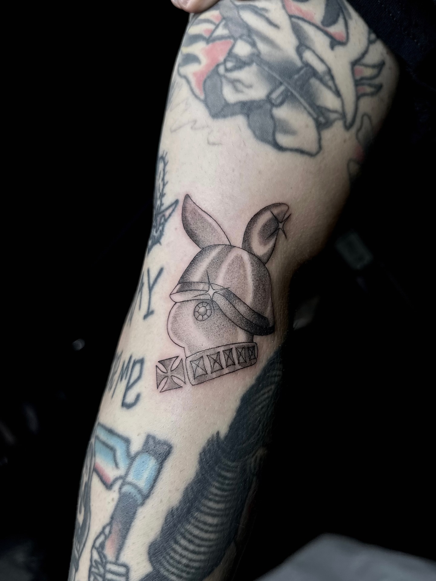 Helmet with iron cross black and grey tattoo on the forearm by Emersyn DeLuna