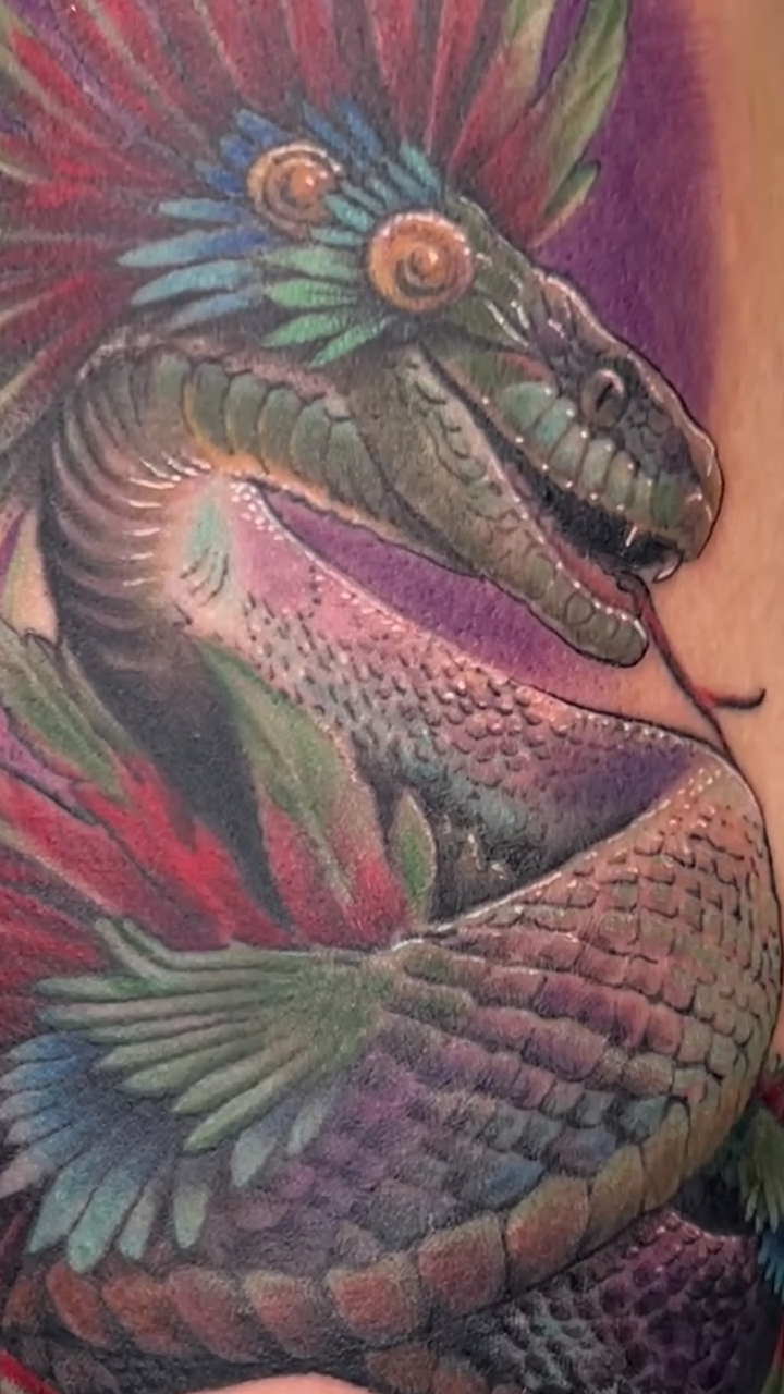 Serpent with feathered headdress realism tattoo by Justin James