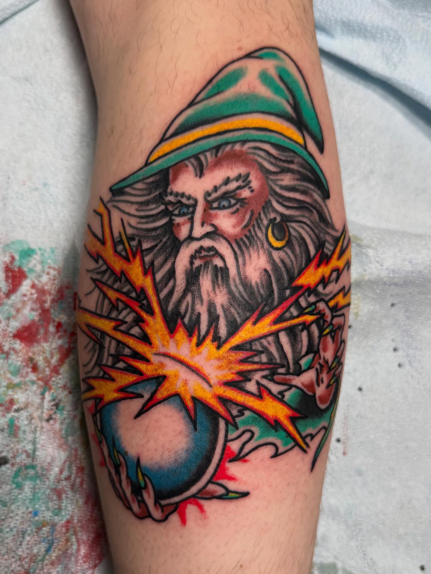 Wizard with lightning American traditional tattoo on the forearm by Bill Crawford, Plymouth, Michigan