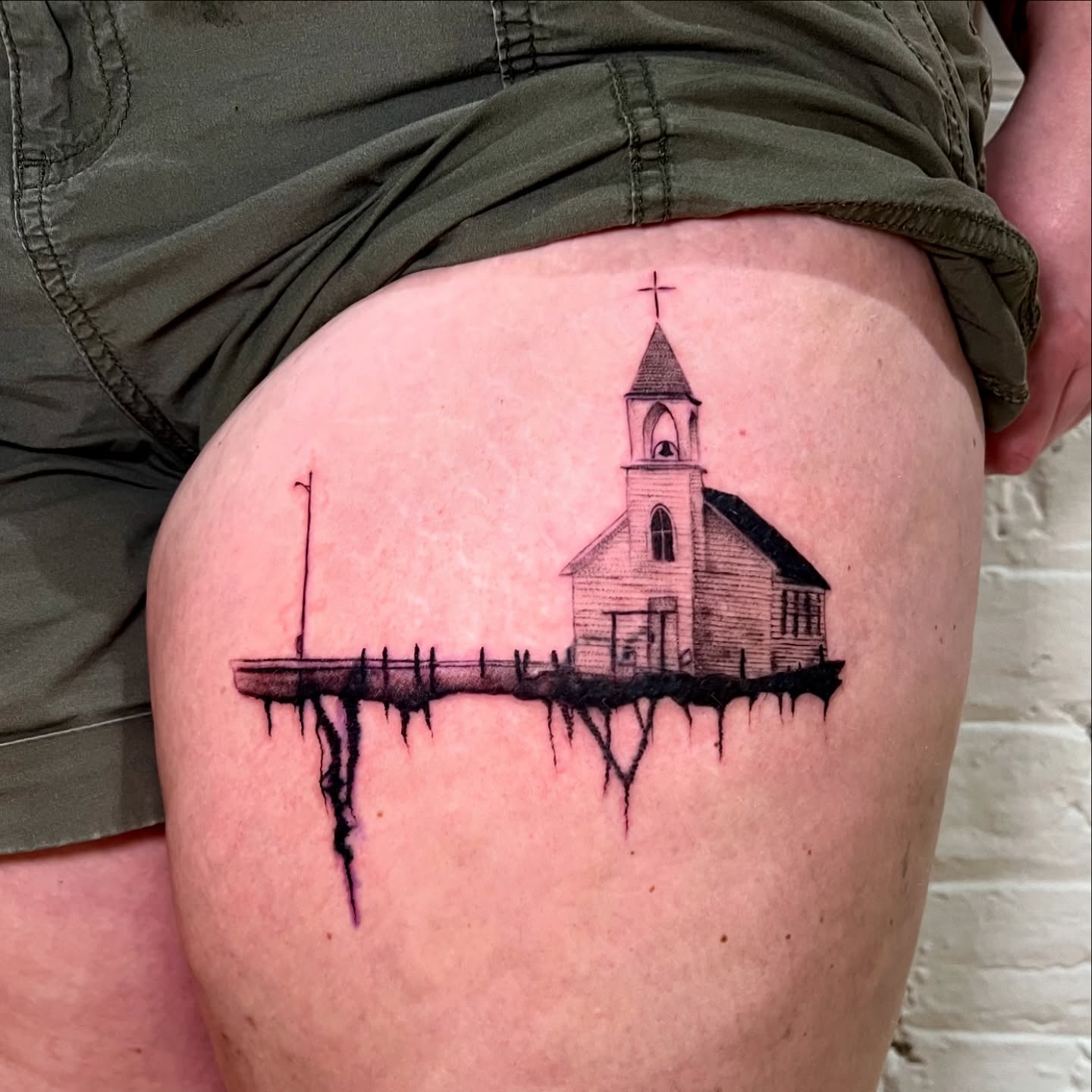 Church black and grey tattoo on the thigh by Maddy Paige