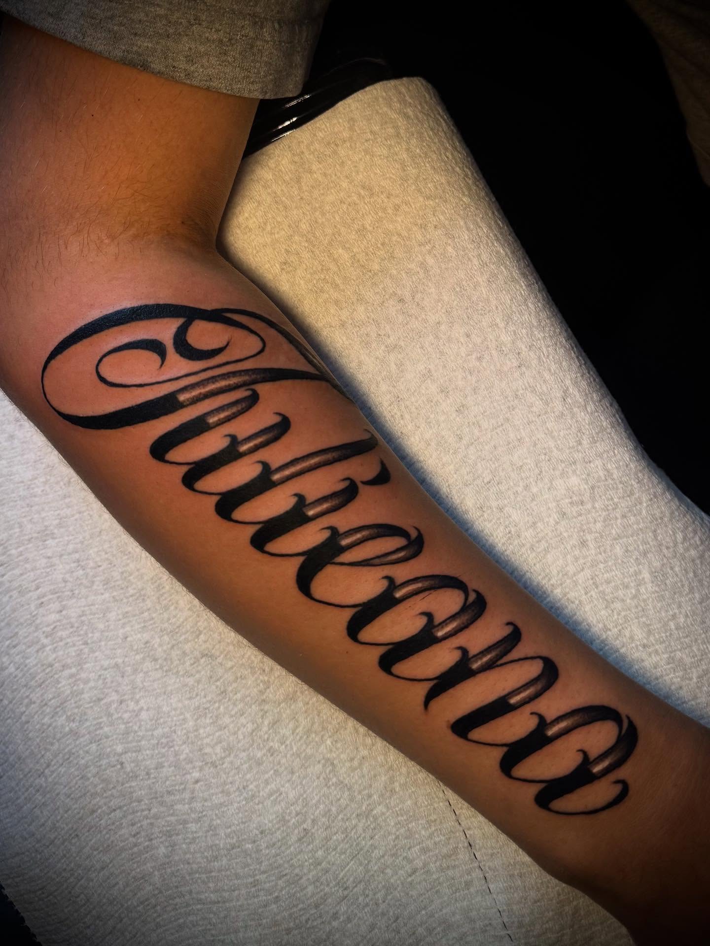 Script lettering lettering script tattoo on the forearm by Tattoo Artist based in Dallas Tx