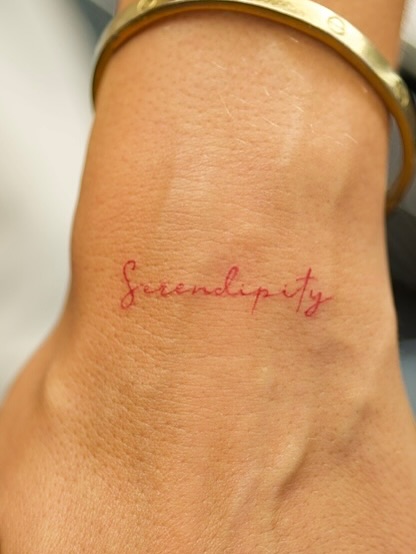 Serendipity lettering script tattoo on the forearm by @blackastaratattoo